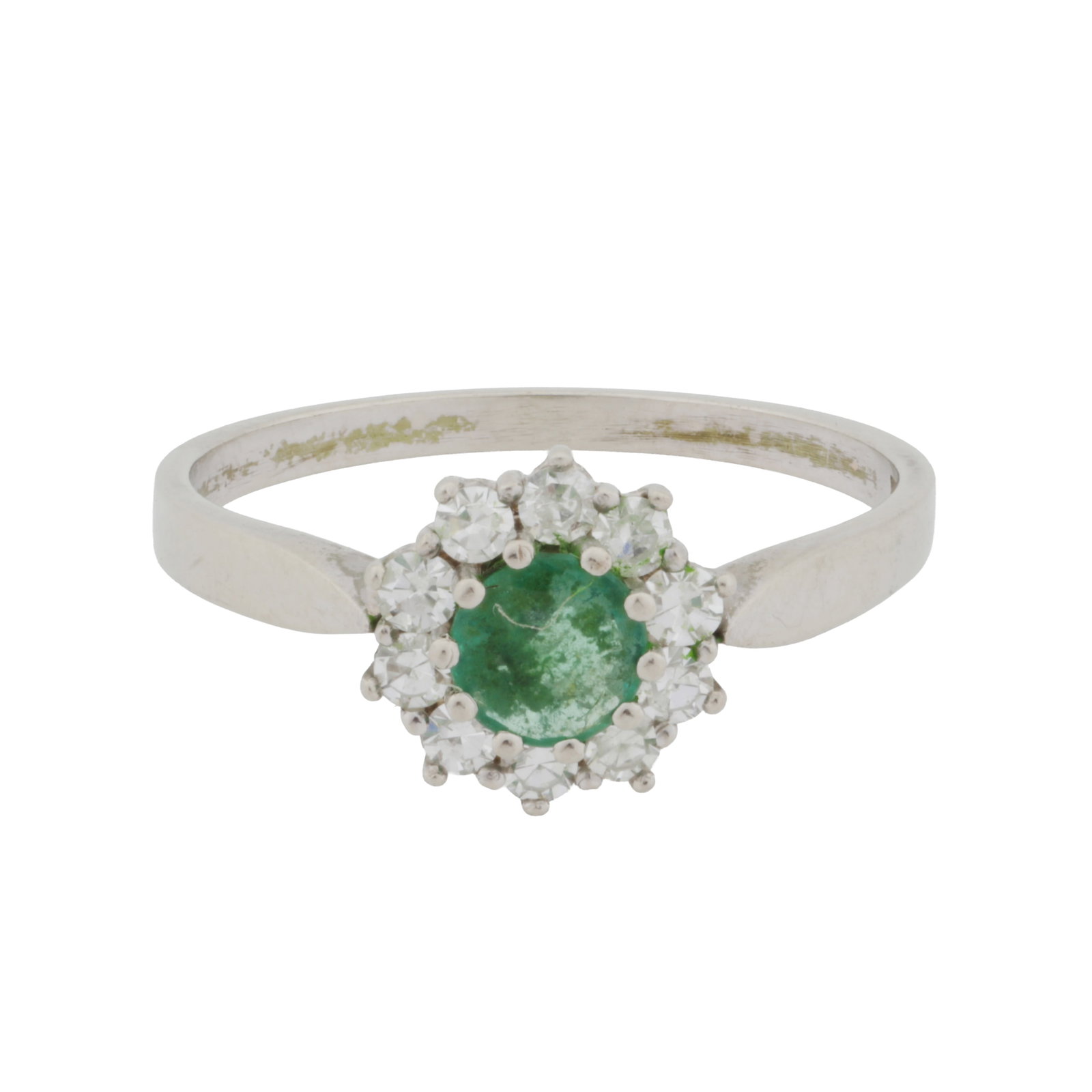 An emerald and white sapphire ring White metal: An emerald and white sapphire ring White metal Of cluster design, set with a round-cut emerald within a surround of white sapphires, to a pinched shank, maker's mark AZ, stamped 585, ring size O