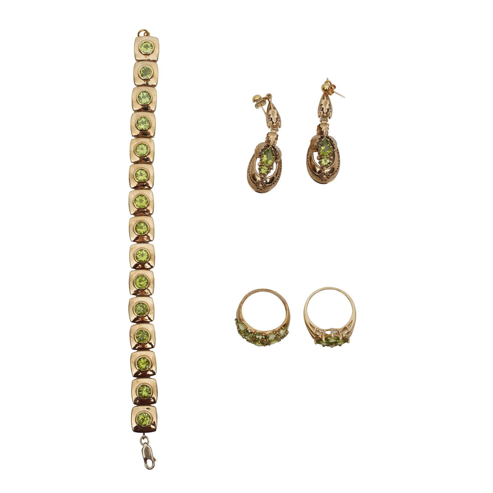 A peridot bracelet, pendent earrings and rings set Yellow metal: A peridot bracelet, pendent earrings and rings set Yellow metal Set with vari-cut peridots, to yellow metal mount; the articulated bracelet stamped 925; the pendant earrings unmarked; the two rings