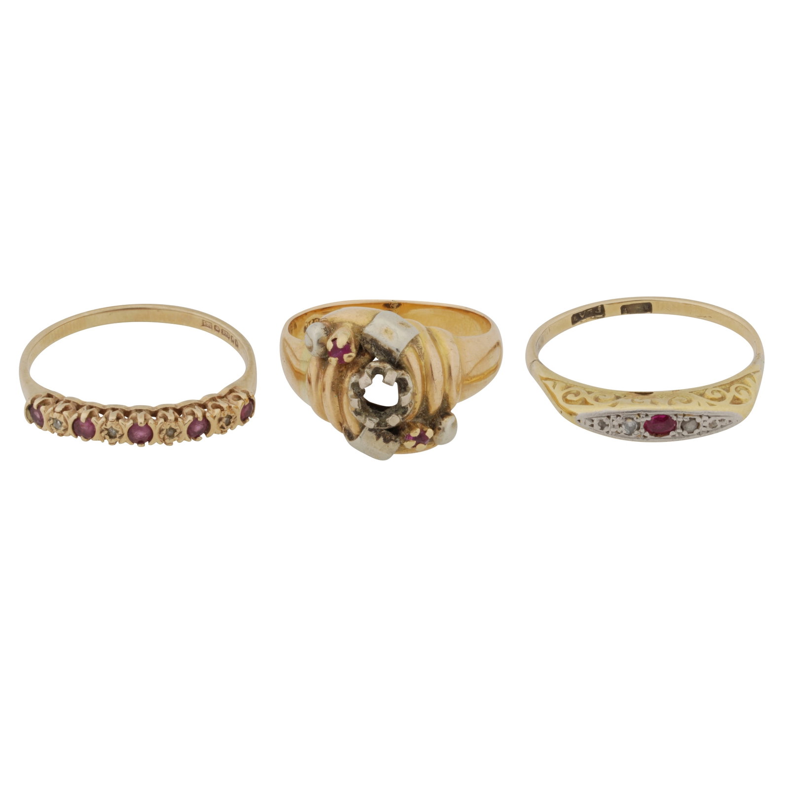 Three gem-set rings Yellow metal: Three gem-set rings Yellow metal Set with rubies and diamonds, all set in yellow metal; one in 9 carat gold, central stone deficient, UK hallmark; one stamped 750; and one stamped 18ct-Plat.; various 