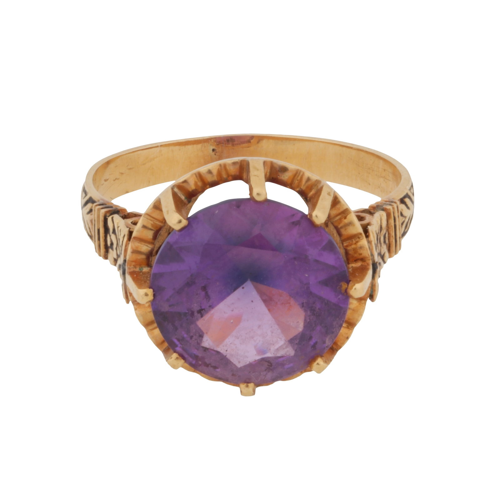 A synthetic purple sapphire single stone ring Yellow metal: A synthetic purple sapphire single stone ring Yellow metal Centrally claw-set with a circular-cut synthetic purple sapphire, to a pierced decorated gallery and shoulders of scroll design, Portuguese