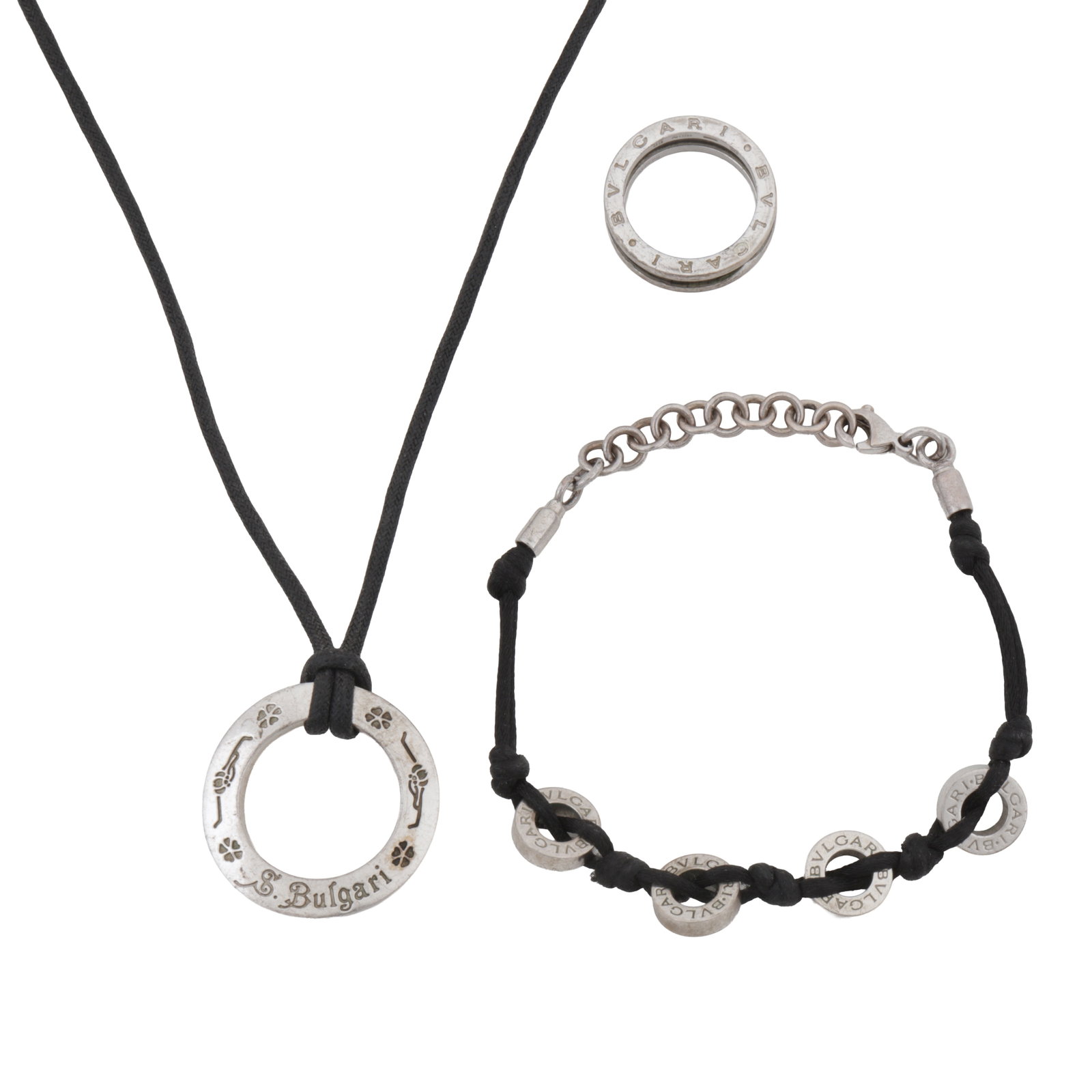 Bulgari | A 'Save the Children' necklace, bracelet, and ring suite Silver: Bulgari | A 'Save the Children' necklace, bracelet, and ring suite Silver To include a circular pendant of openwork design, a B.Zero1 black ceramic ring, and a matching bracelet; signed, Italian