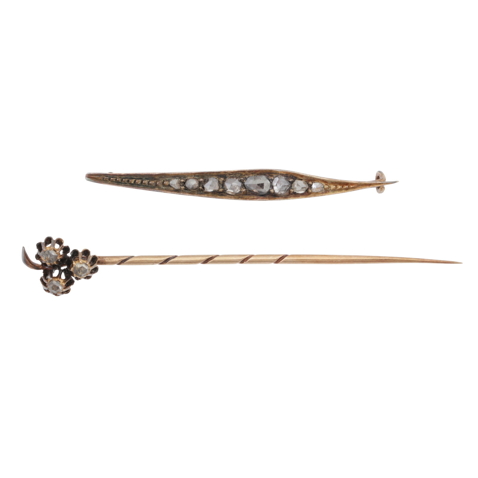 A diamond pin and a diamond brooch Yellow and white metal: A diamond pin and a diamond brooch Yellow and white metal The pin designed as a floral spray set with three rose-cut diamonds in 14k yellow gold, with Austro-Hungarian assay mark and stamped
