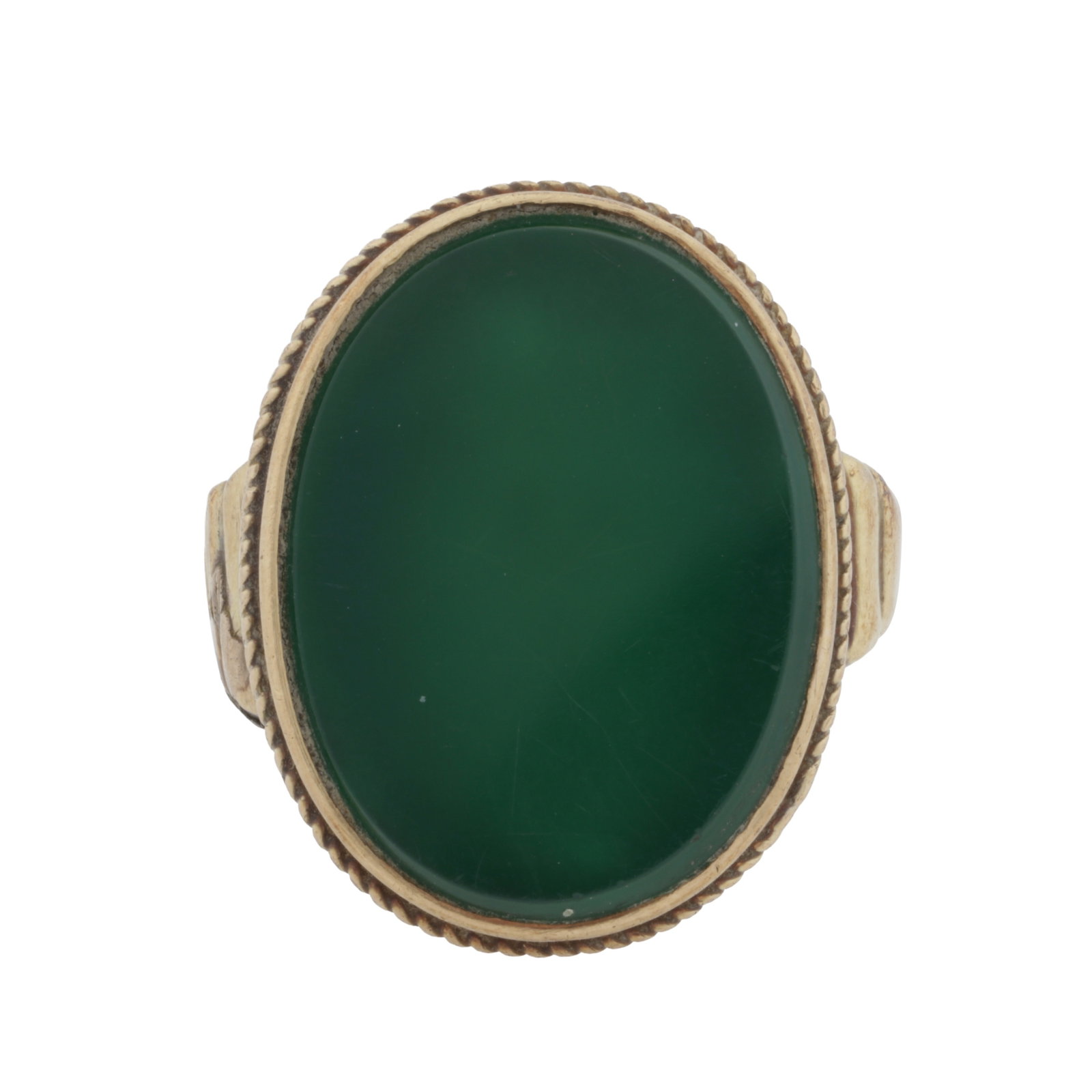 A green calcedony ring Yellow metal: A green calcedony ring Yellow metal Of oval shape, to ropetwist and ridded detailing, set in yellow metal, Hungarian assay mark, ring size S