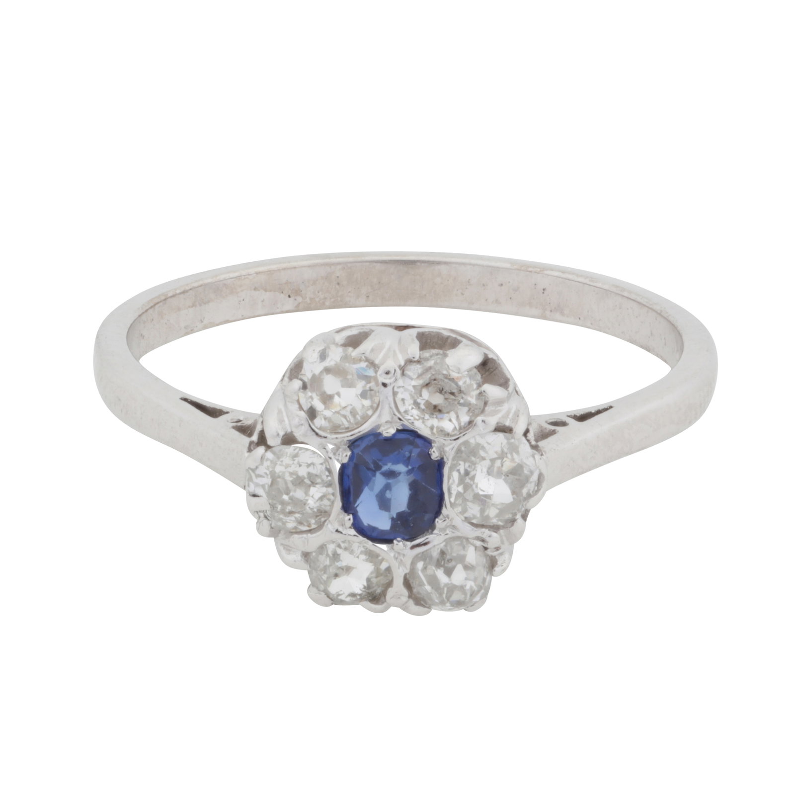 A sapphire and diamond halo ring White metal: A sapphire and diamond halo ring White metal Claw-set with a cushion-cut sapphire, surrounded by old-cut diamonds, to a pierced gallery and cathedral setting, on a straight band, diamonds approx. 0.30
