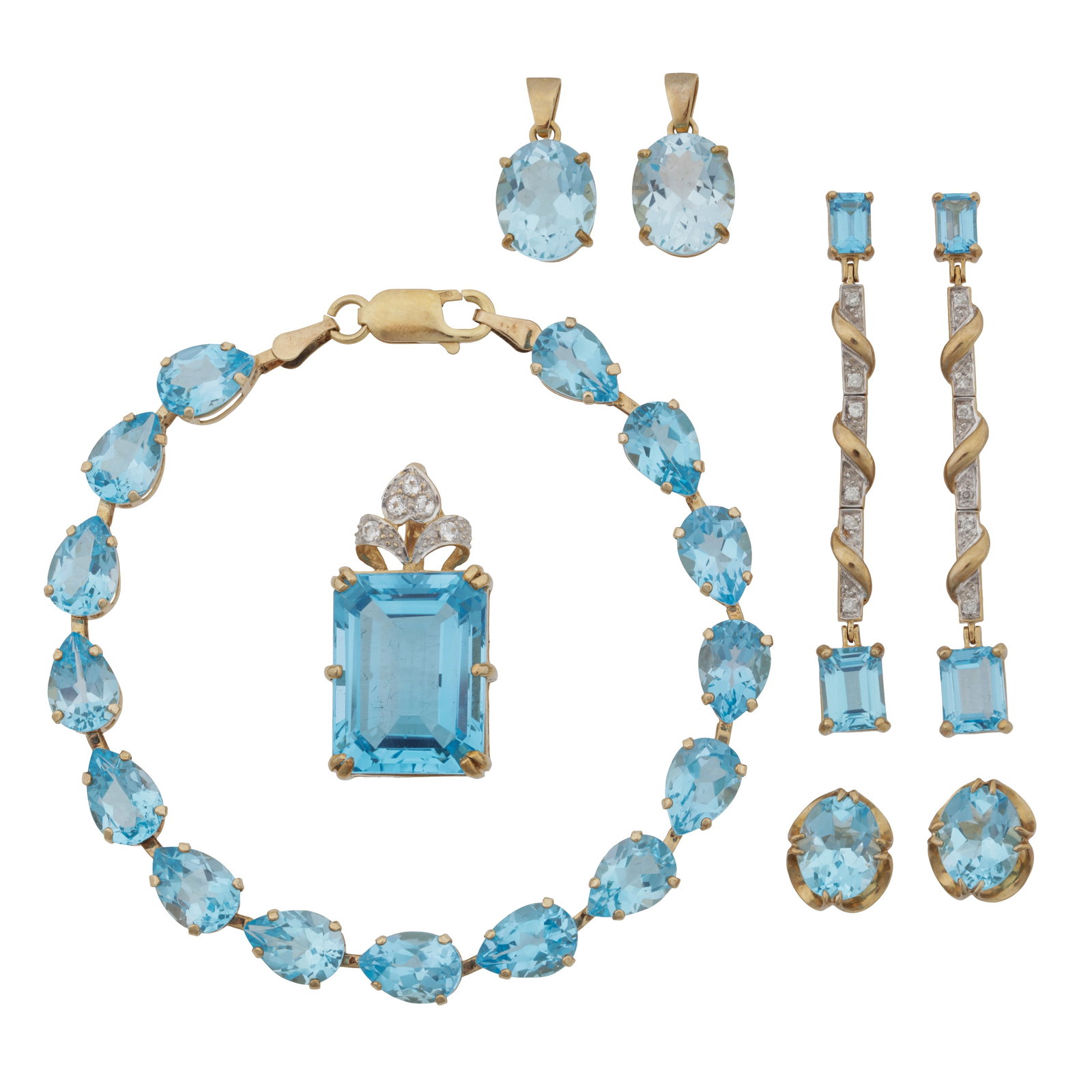 A blue topaz and gold group of jewellery 9 carat yellow gold: A blue topaz and gold group of jewellery 9 carat yellow gold Comprising of a line bracelet; a pair of pendent earrings; a pair of studs; a topaz and diamond pendant; and two further pendants; set