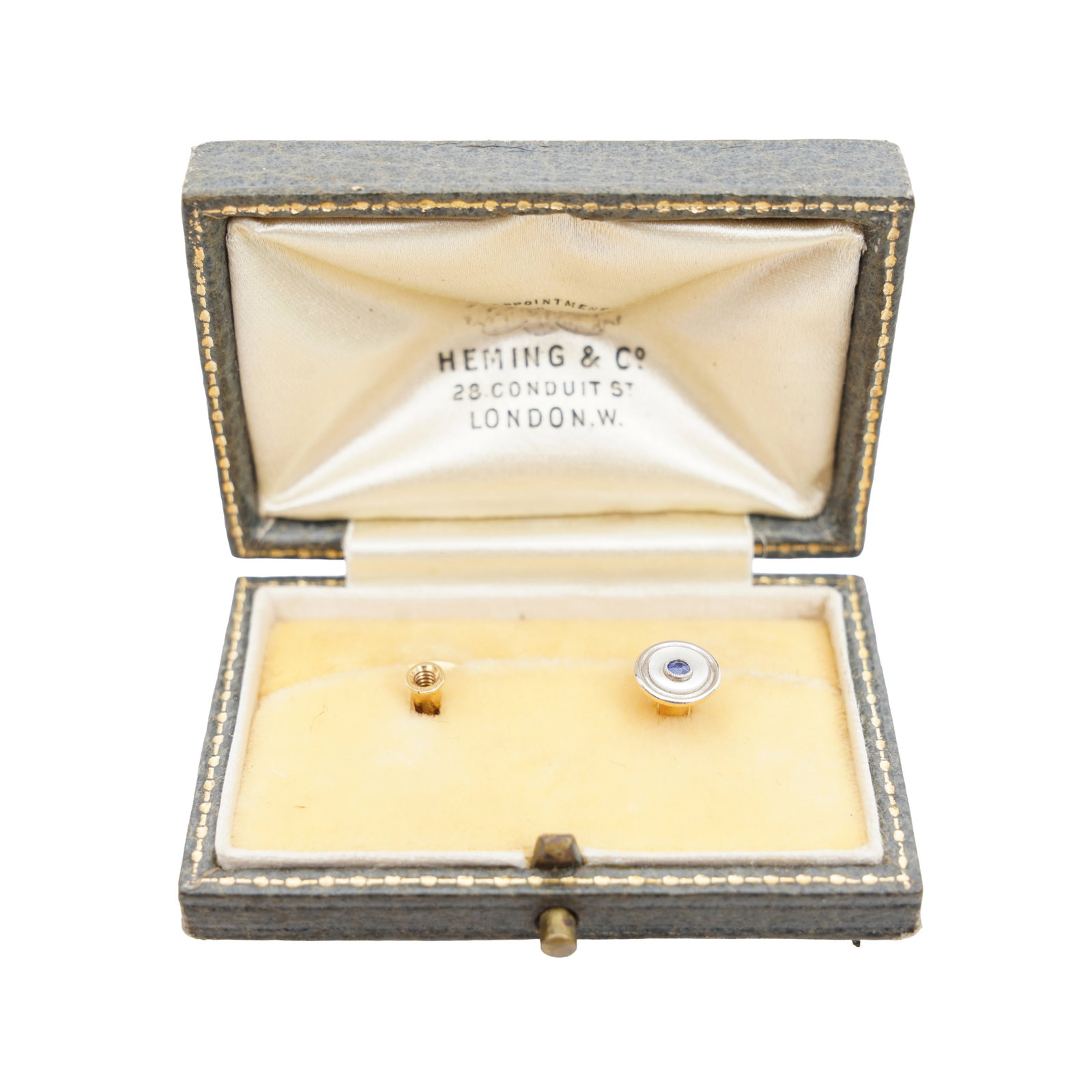 A sapphire and mother of pearl dress stud Yellow and white metal: A sapphire and mother of pearl dress stud Yellow and white metal Set with a circular-cut sapphire, within a mother of pearl surround, to millegrain detailing, mounted in yellow and white metal,