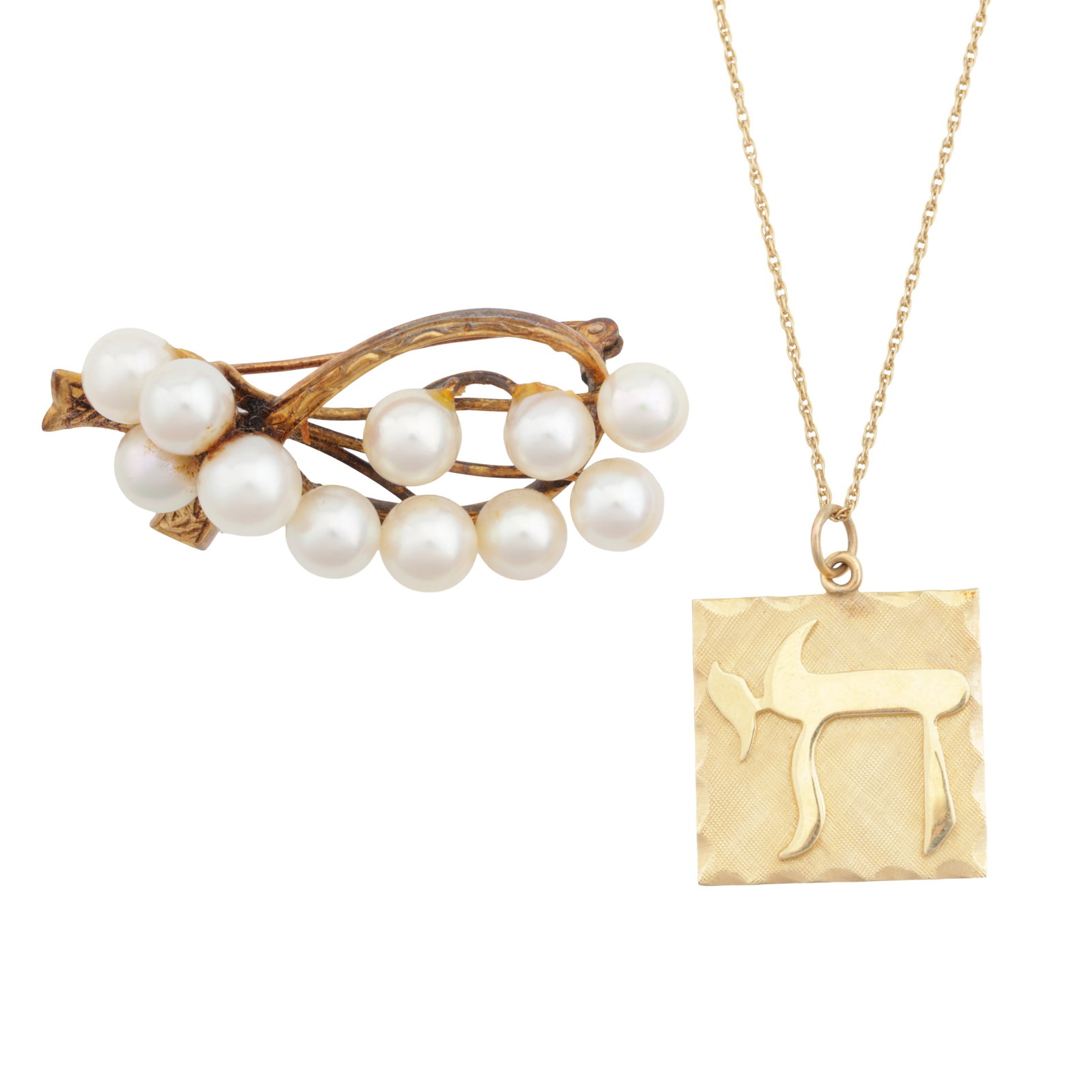 A pendant necklace and a pearl brooch Yellow metal: A pendant necklace and a pearl brooch Yellow metal the chain of twisted links suspending a rectangular textured plaque with a polished arabic inscription at its front, set in yellow metal, both