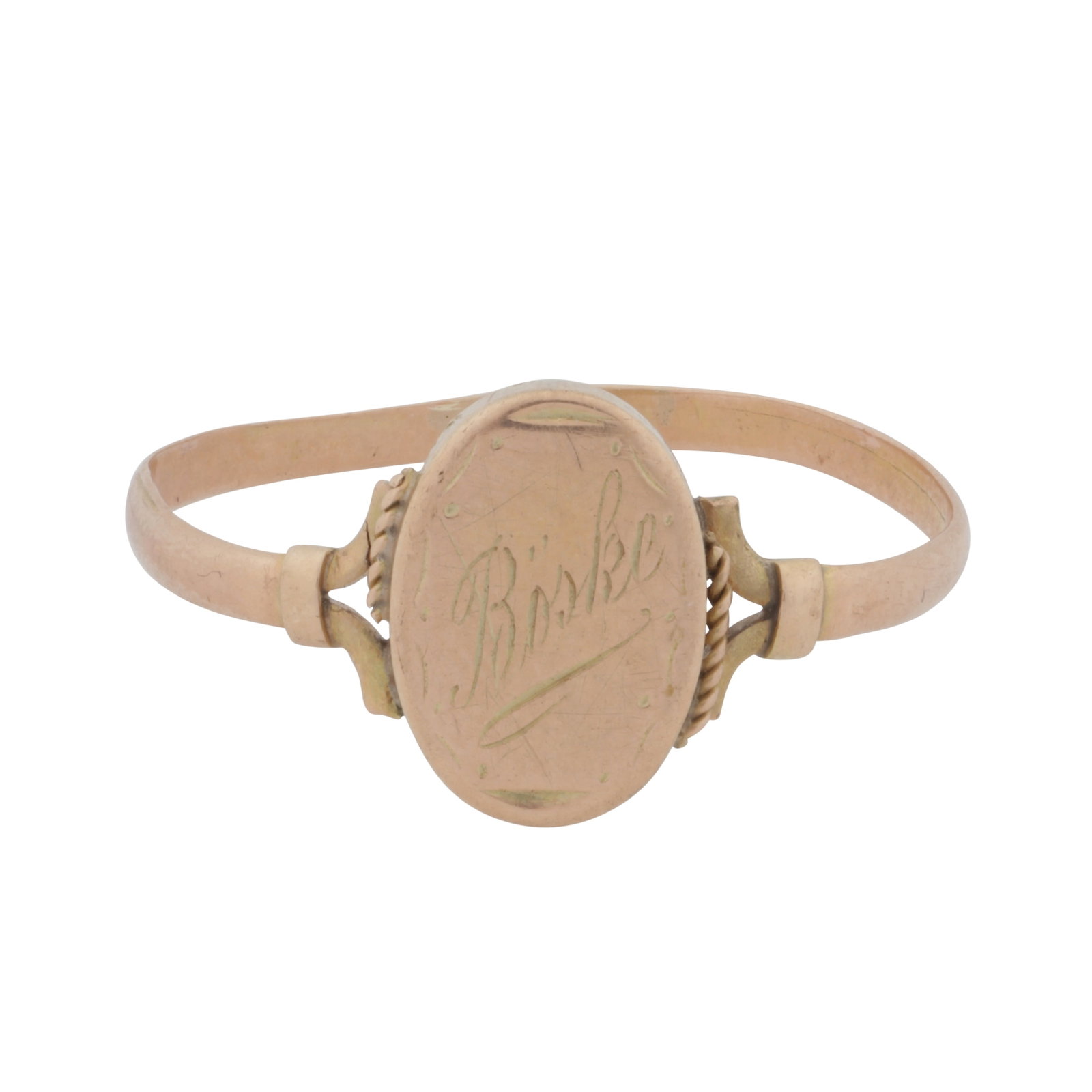 An engraved ring Yellow metal: An engraved ring Yellow metal Of oval design, engraved in the centre, with rope-twist decorations, bifurcated shoulders, straight band, unmarked, size W The item has been XRF tested and found to be