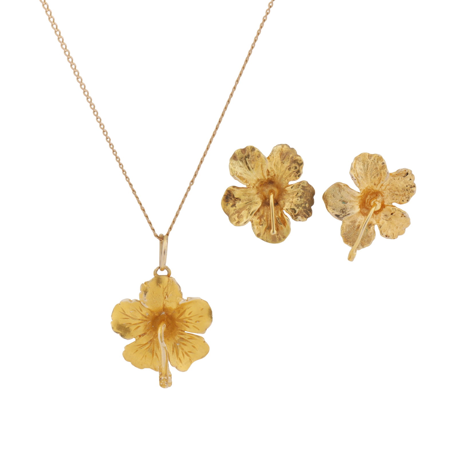 A flower pendant necklace and earrings suite Yellow metal: A flower pendant necklace and earrings suite Yellow metal The textured flower pendant, suspended from a curb-link chain necklace, together with a pair of matching stud earrings, unmarked, lengths: