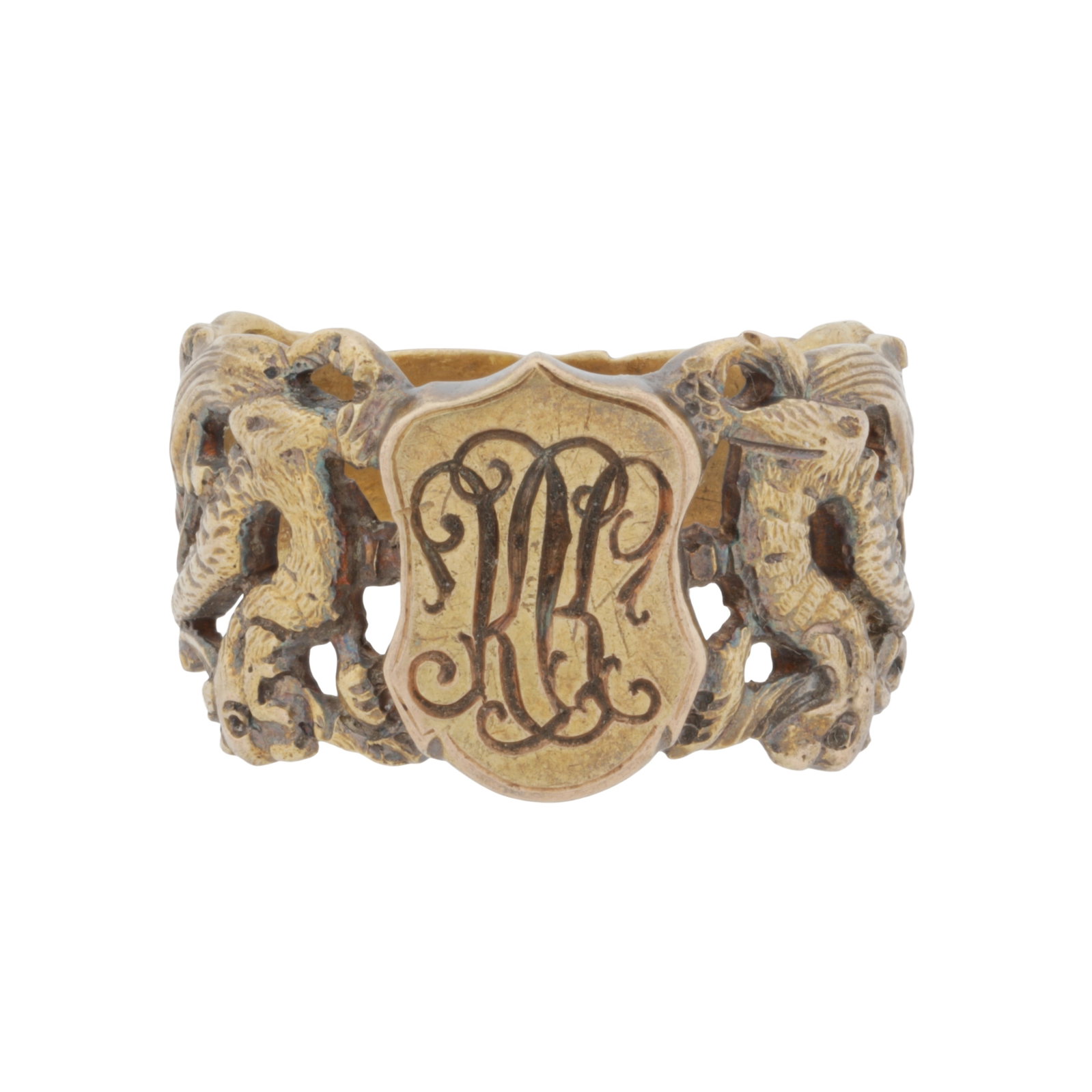 A signet ring Yellow metal: A signet ring Yellow metal Decorated with an engraved monogram, to a pierced shoulders decorated with chimeras and floral motifs, set in yellow metal, unmarked, ring size T½ The item has been XRF