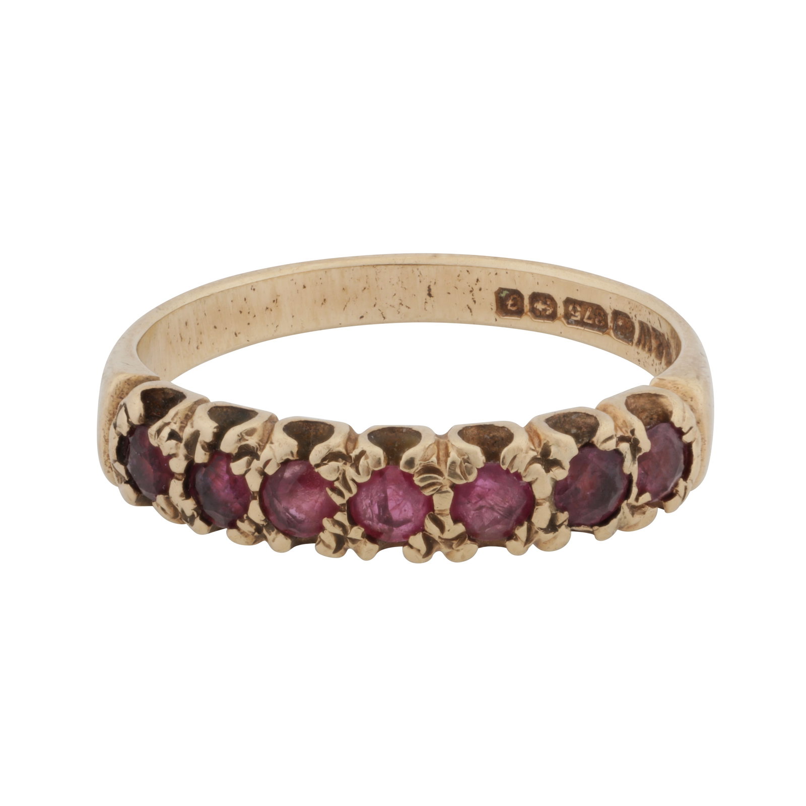 A ruby seven stone ring 9ct yellow gold: A ruby seven stone ring 9ct yellow gold Set with circular-cut rubies, decorated gallery, tapered band, maker's mark, UK hallmark, size M½