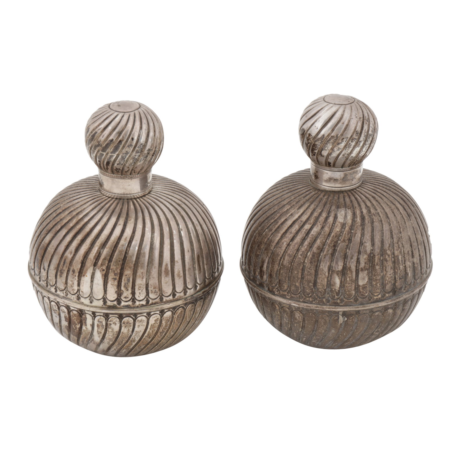 Birmingham 1887 by George Unite A pair of Victorian sterling mounted scent bottles: Birmingham 1887 by George Unite A pair of Victorian sterling mounted scent bottles Of rounded circular form with glass interiors. Spirally fluted decoration. Fully marked underneath. (2) Height -13.4
