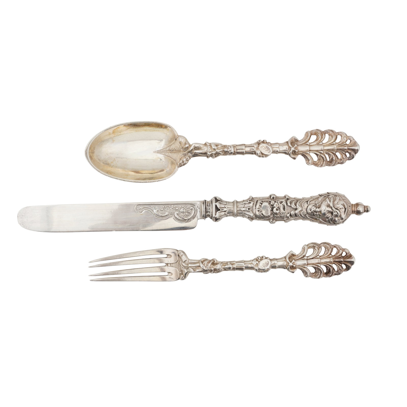 London 1856 by Francis Higgins A Victorian sterling silver christening set: London 1856 by Francis Higgins A Victorian sterling silver christening set Ornate open work design, oval cartouche engraved with initials JEKS. (3) Weight – 101 grams / 3.25 ozt