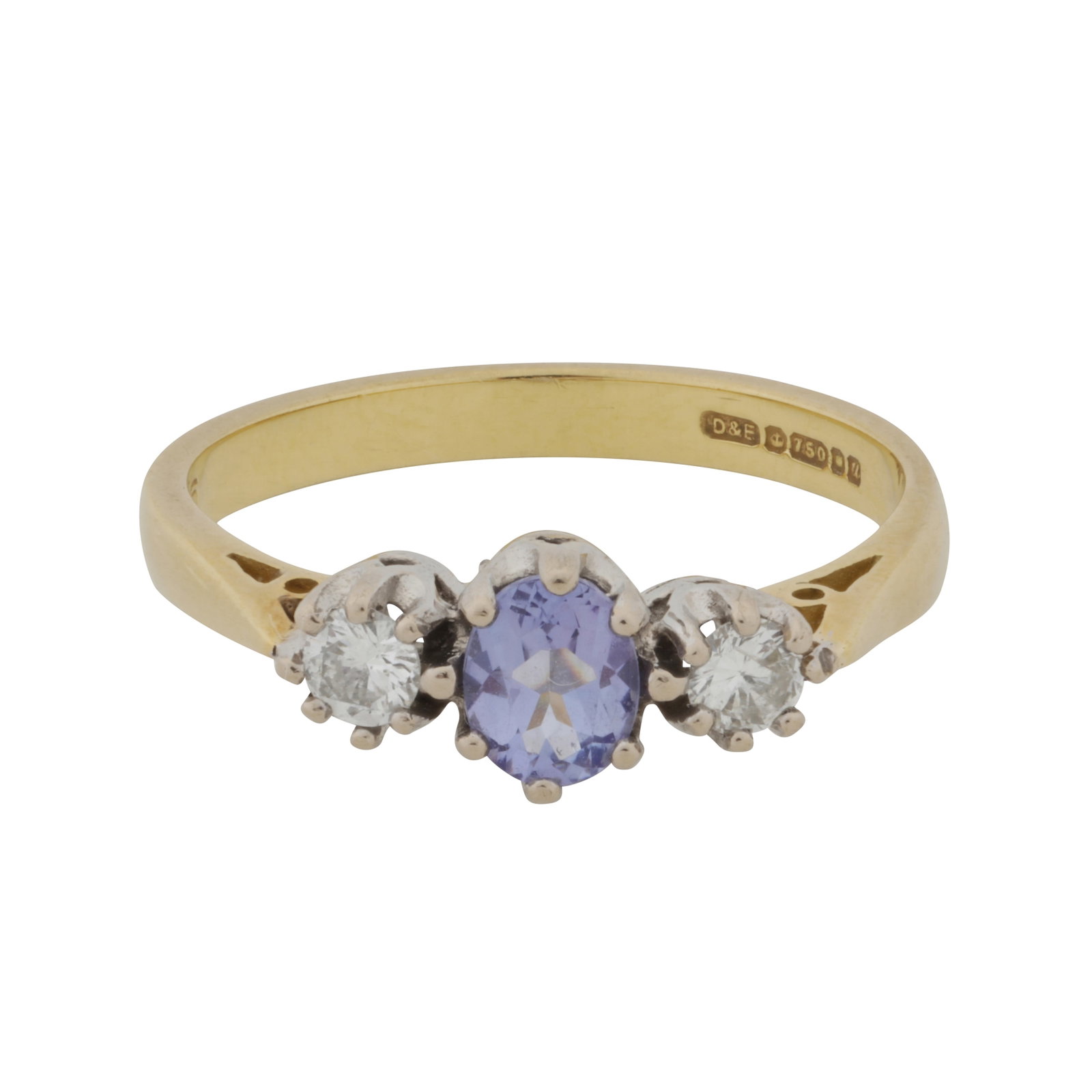 A tanzanite and diamond three stone ring 18ct yellow and white gold: A tanzanite and diamond three stone ring 18ct yellow and white gold Claw-set with an oval-cut tanzanite centre, flanked by brilliant-cut diamonds, to cathedral setting and tapered shoulders, maker's