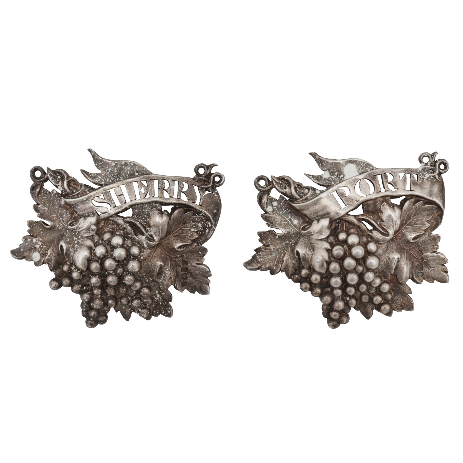 London 1835 by Riley and Storer A pair of William IV sterling silver wine or decanter labels: London 1835 by Riley and Storer A pair of William IV sterling silver wine or decanter labels Cast, formed as fruiting vine pierced with PORT and SHERRY. Chain deficient (2) Length - 6.5 cm / 2.55