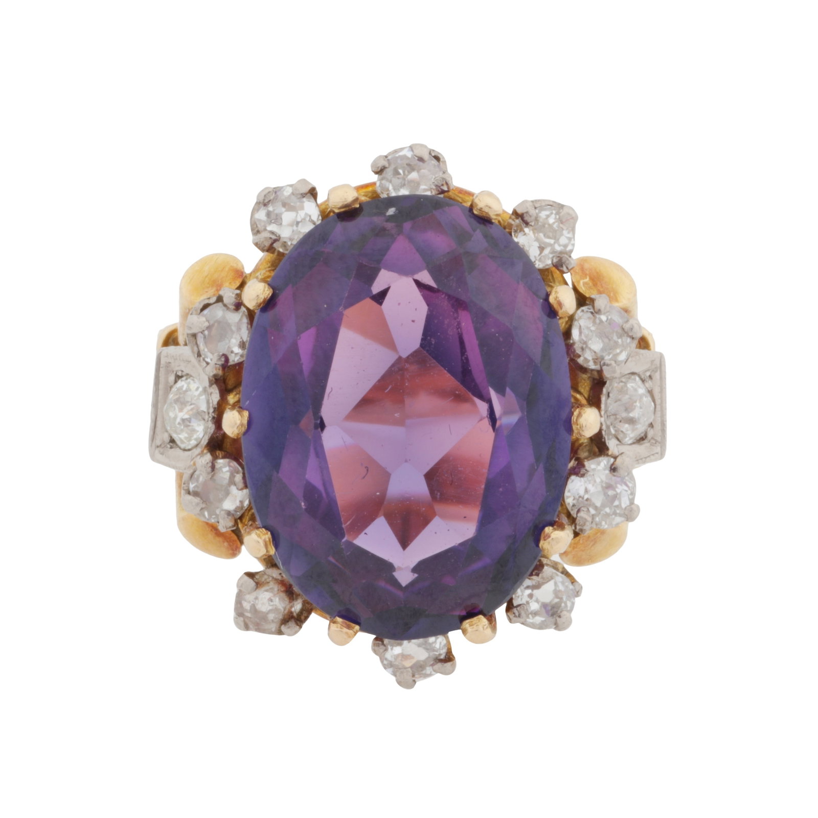 A synthetic sapphire and diamond ring Yellow and white metal: A synthetic sapphire and diamond ring Yellow and white metal Centrally set with an oval-cut synthetic sapphire, surrounded by old-cut diamonds, trifurcated shoulders and wired band, stamped K18, size