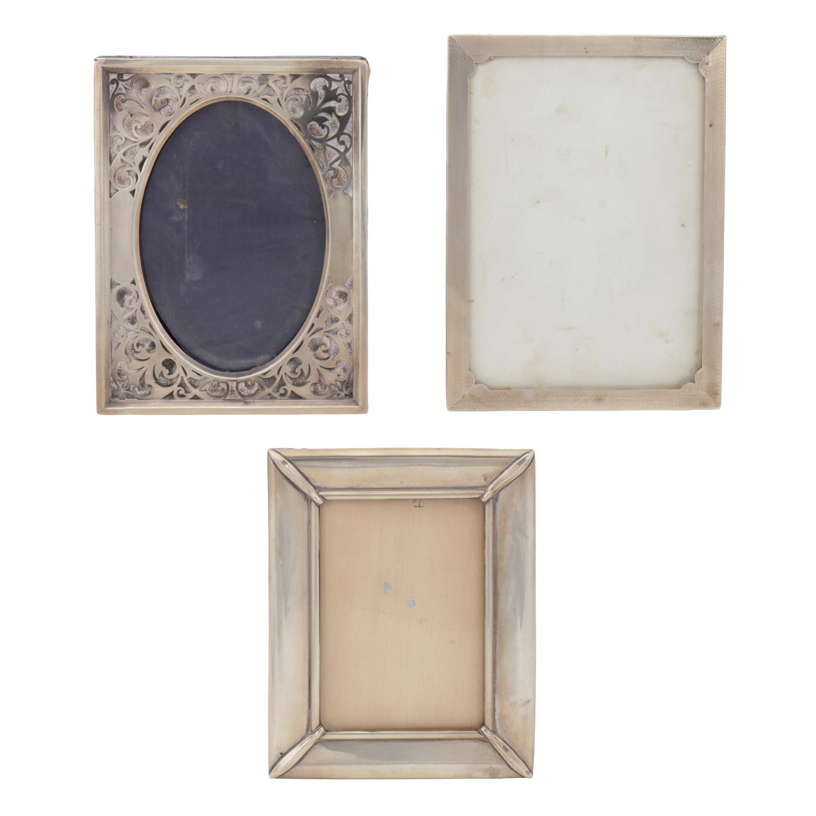 Birmingham 1909 by Henry Matthews An Edwardian sterling silver photograph frame: Birmingham 1909 by Henry Matthews An Edwardian sterling silver photograph frame Of rectangular form with a pierced corners of scrolling decoration. Together with an engine turned photograph frame,