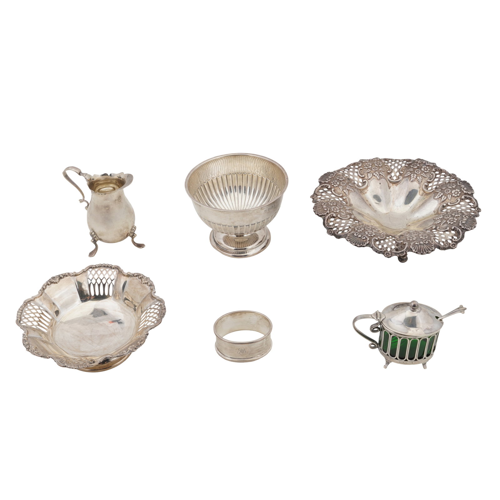 A mixed group of sterling silver: A mixed group of sterling silver Comprising a mustard pot, a footed flute bowl, a cream jug, an embossed and pierced footed dish, and another. (Q) Weight - 512 grams / 16.46 ozt