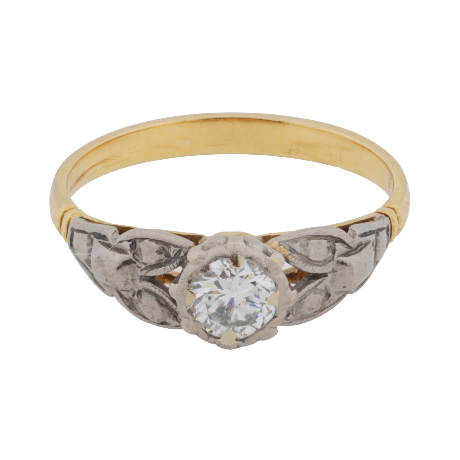 A single stone diamond ring Yellow and white metal: A single stone diamond ring Yellow and white metal Claw-set with a brilliant-cut diamond centre, to leaf decorated shouldered, unmarked, size N½ The item has been XRF tested and found to be the
