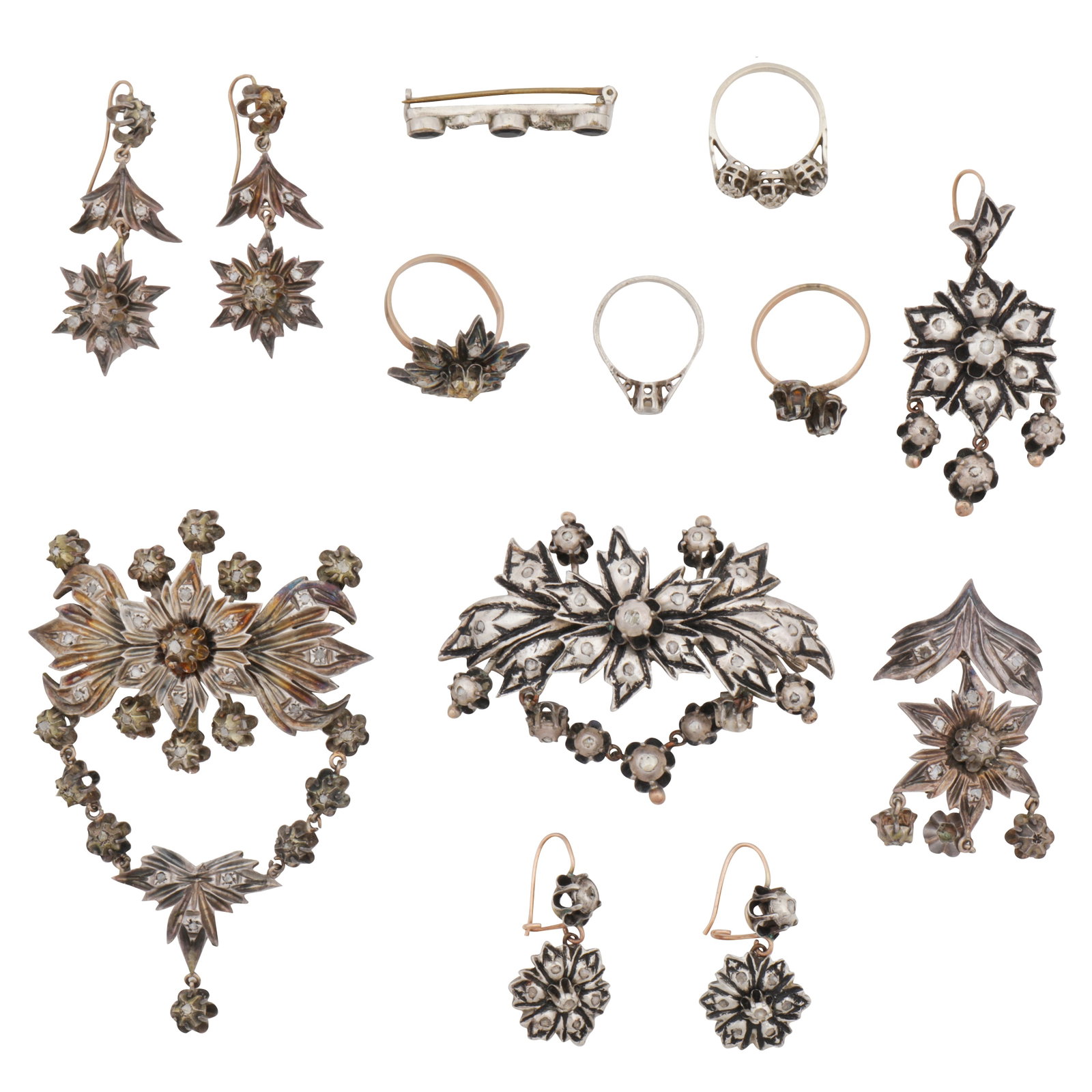 A group of gem-set jewellery White and yellow metal: A group of gem-set jewellery White and yellow metal Including three brooches; two pendants; two pairs of earrings; four rings; featuring rose cut diamonds; all set in white and yellow metal, one ring