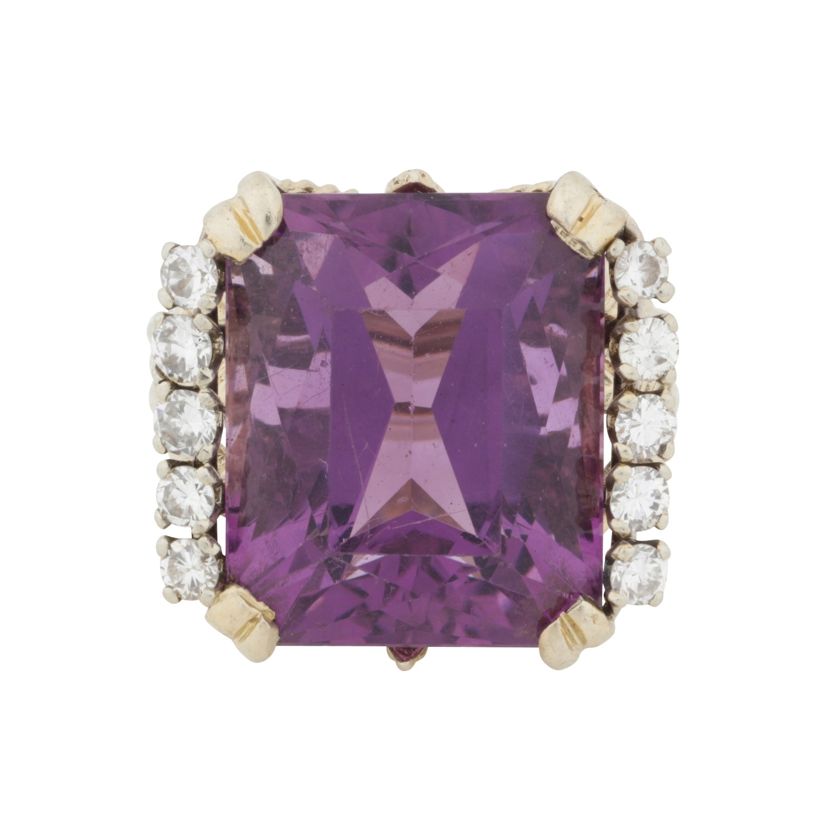 An amethyst and diamond ring Yellow metal: An amethyst and diamond ring Yellow metal The octagonal mixed-cut amethyst, shouldered by brilliant-cut diamonds, to wheat motif shoulders, diamonds approx. 0.50 carat total, ting size L½ The