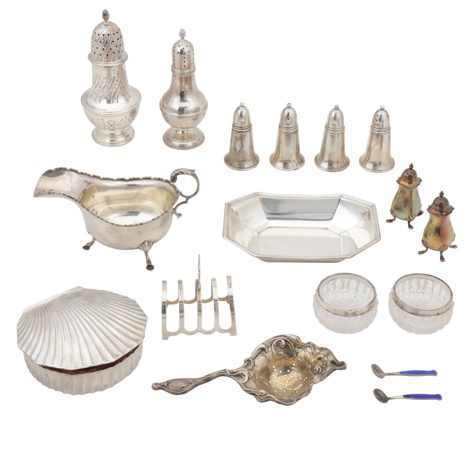 A mixed group of sterling silver: A mixed group of sterling silver Comprising two sugar casters, a sauce boat, a tea strainer, pair of peppers, a toast rack, an American dish by Gorham, a Mexican jewellery box with fabric interior.