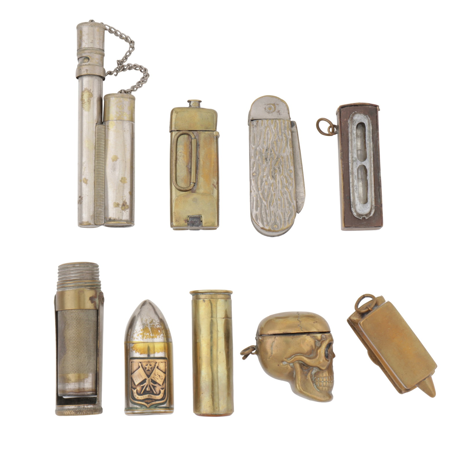 A mixed group of brass vesta cases: A mixed group of brass vesta cases A mixed group of brass vesta cases One formed as a skill, one as a level, one as a billet with flag upon it, one formed as a pen knife, one as an anvil, one