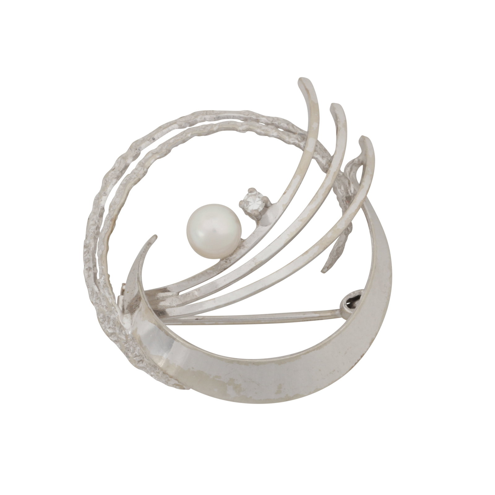 A pearl and white sapphire brooch White metal: A pearl and white sapphire brooch White metal Of circular openwork design, to textured decorations, set with a pearl and a circular-cut white sapphire, pin and catch, maker's mark, stamped 585,