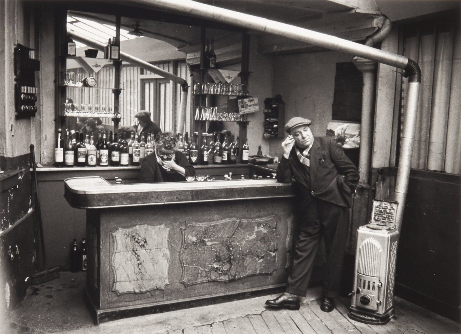 § Willy Ronis (1910-2009) Chez Victor, Paris, 1955: Silver gelatin print, printed 1994, image size 24.5 x 34.5cm, sheet size 30.5 x 40.5cm, signed by the photographer in ink lower margin recto, titled, dated, numbered, and annotated by the photographer