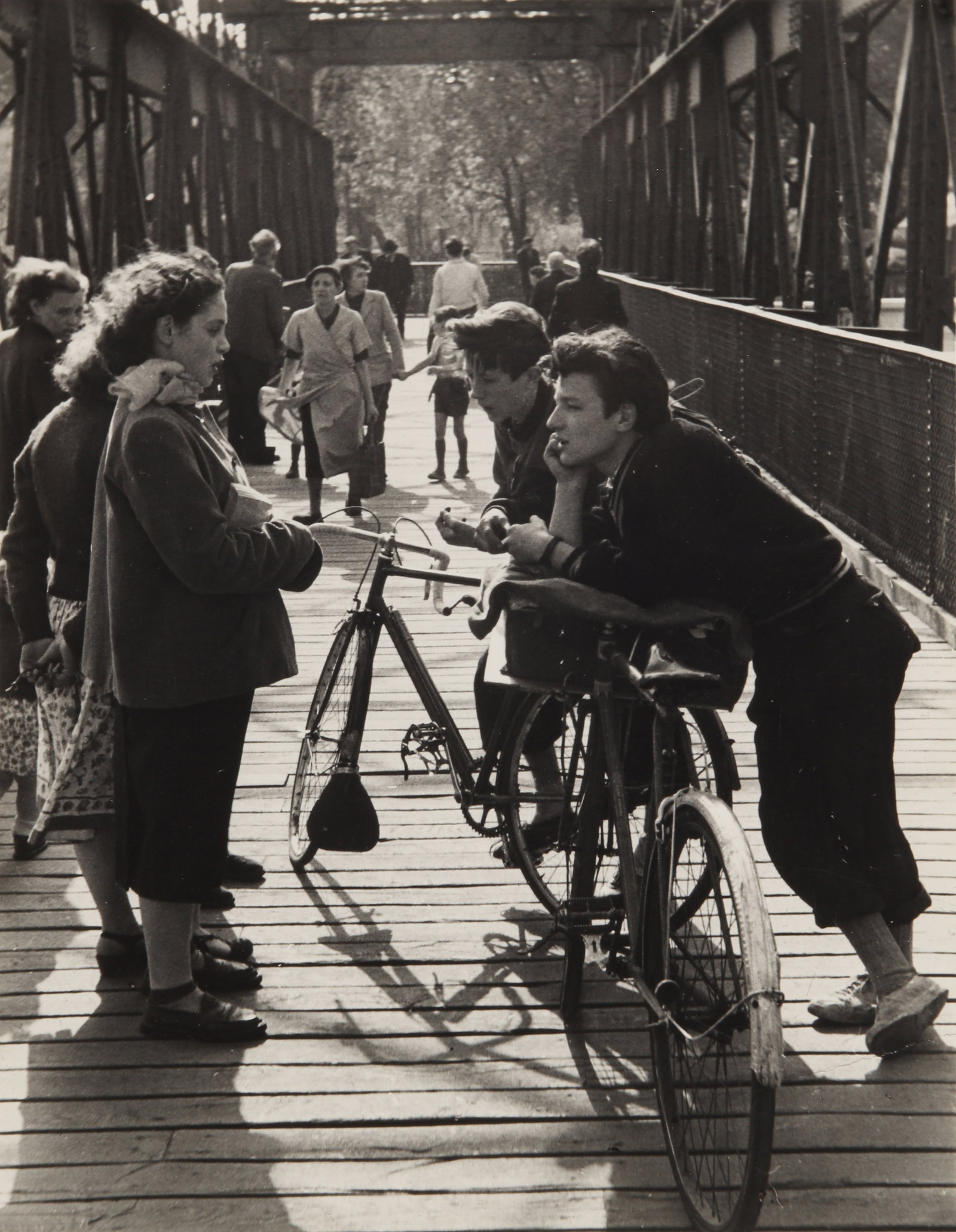 § Edouard Boubat (1923-1999) Rencontre, Passerelle, Paris, 1952: Vintage silver gelatin print, image/sheet size 24 x 18.5cm, captioned, dated, and annotated by the photographer in pencil verso, with Boubat's credit stamp verso. Provenance:From the collection of Fre