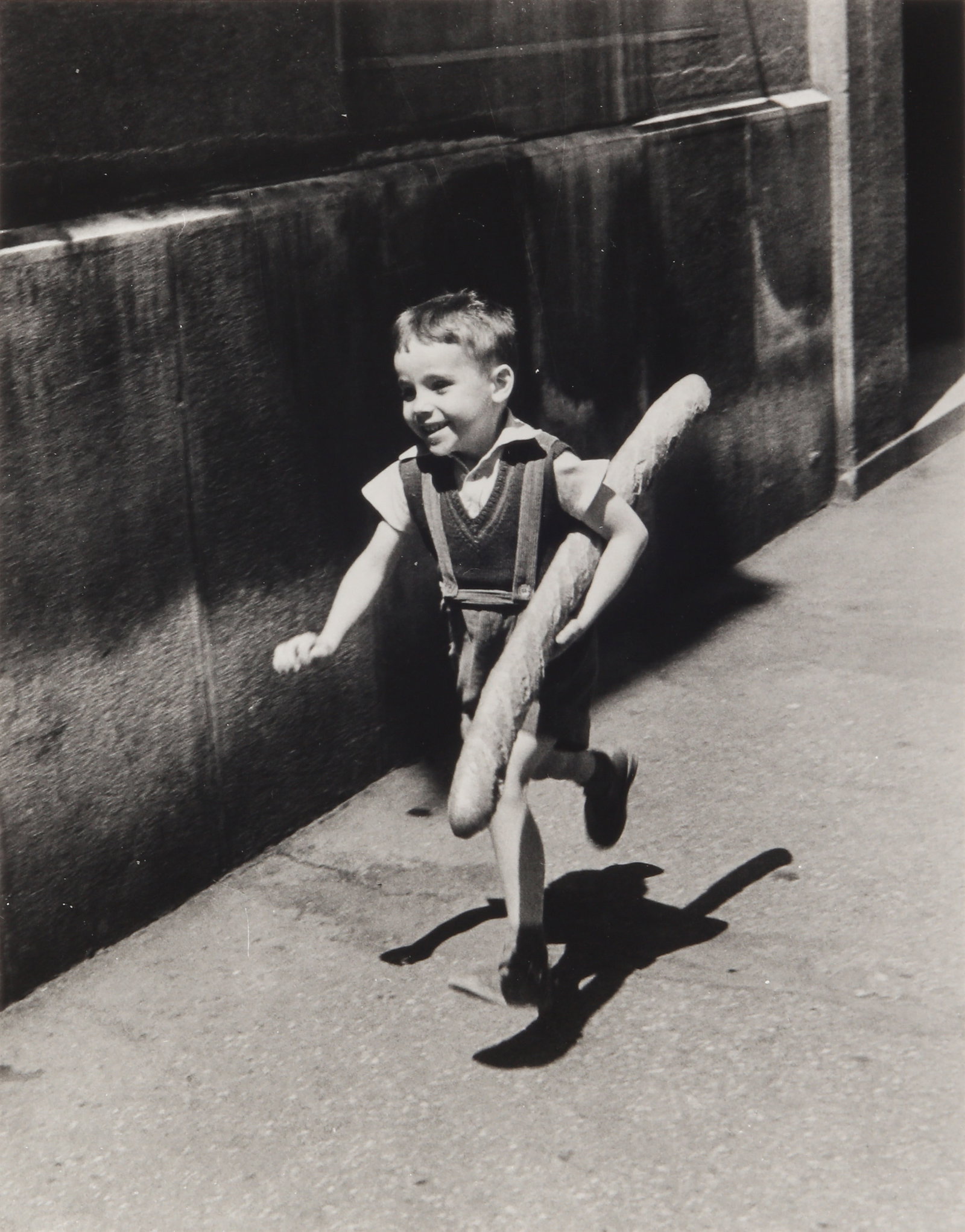 § Willy Ronis (1910-2009) Le Petit Parisien, Paris, 1952: Silver gelatin print, printed 1997, image size 32.3 x 25.3cm, sheet size 40.5 x 30.2cm, signed by the photographer in ink lower margin recto, signed, titled, and dated by the photographer in pencil ve