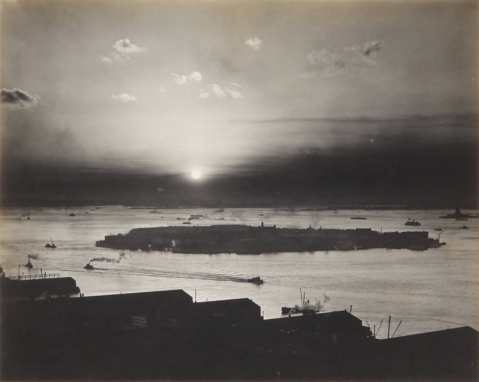 Edward Weston (1886-1958) Sunset View from the Roof of the St George Hotel, Brooklyn, 1941: Vintage silver gelatin print, flush-mounted to original card, image size 19.5 x 24cm, card size 22.5 x 28cm, initialed, dated, and inscribed with a copyright symbol by the photographer in pencil lower