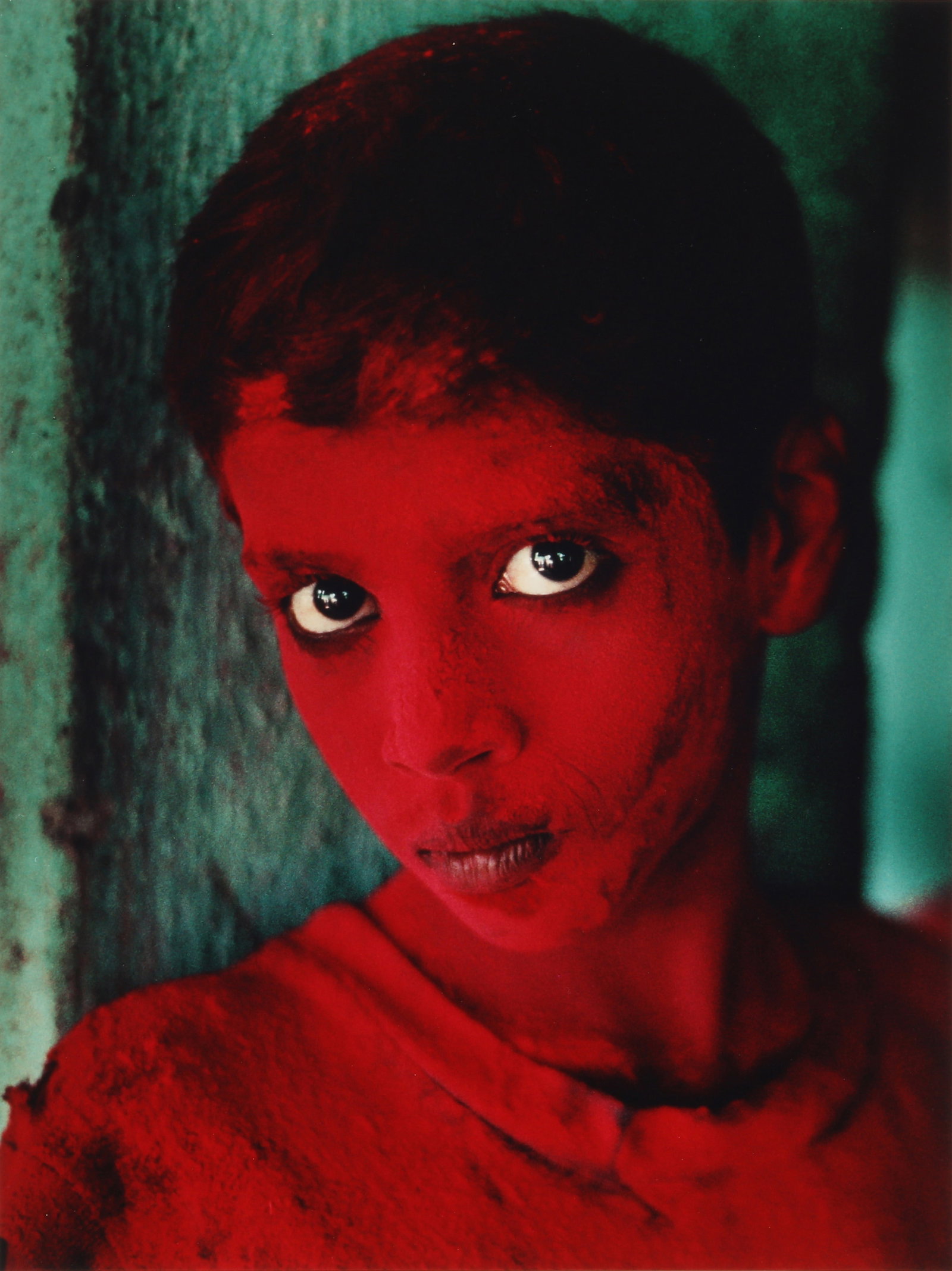 Steve McCurry (b.1950) Red Boy, Ganesh Chaturthi Festival, Mumbai, India, 1996: Vintage chromogenic print, printed 1998, image size 41 x 30.5cm, sheet size 51 x 38.5cm, signed and editioned 3/25 by the photographer in ink lower margin recto. Framed, frame size 65 x 53cm. A unique
