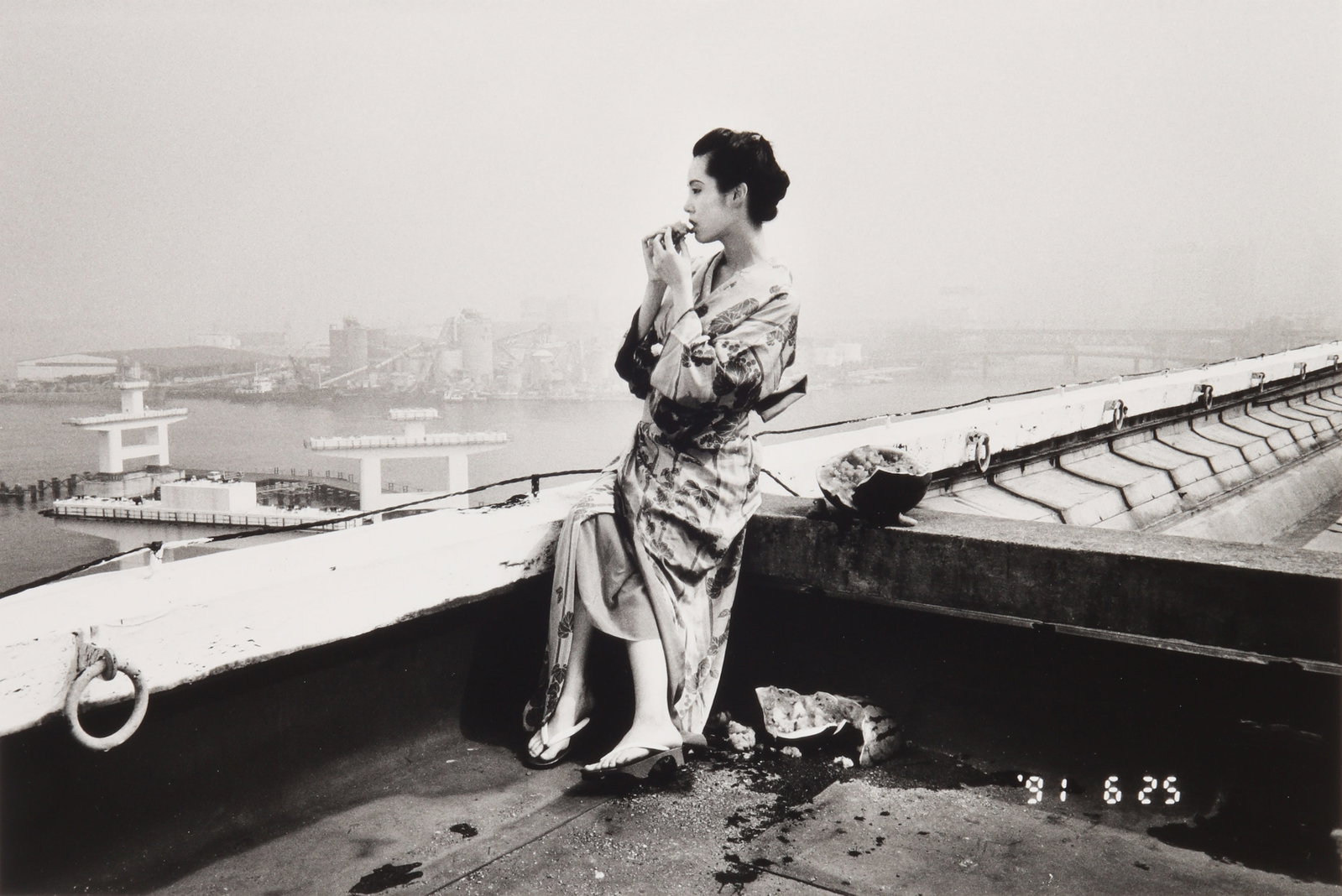 Nobuyoshi Araki (b.1940) Photo Maniac's Diary [Watermelon on the Rooftop], 1991: Silver gelatin print, printed later, image size 27 x 40.2cm, sheet size 35.5 x 43cm, signed by the photographer in pencil verso. Provenance:Acquired by the present owner from Gallery13, Italy