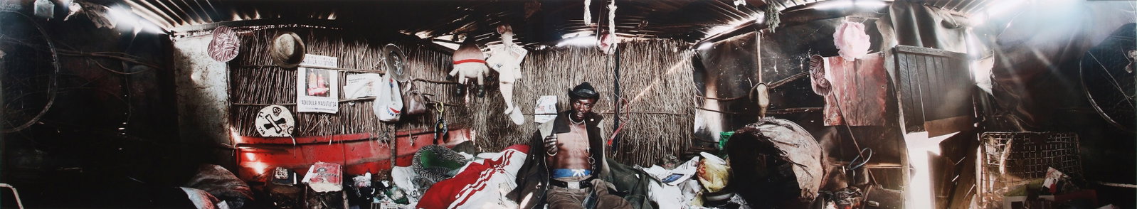 Mikhael Subotzky (b.1981) Joseph Dlamini (in home), Matsho Tsmombeni Squatter Camp, South Africa,: Oversized archival pigment print panorama, image size 47 x 255cm, sheet size 56 x 265cm, edition 4/7. Archivally mounted and framed, frame size 70 x 278cm. Accompanied by a signed Certificate of Authe
