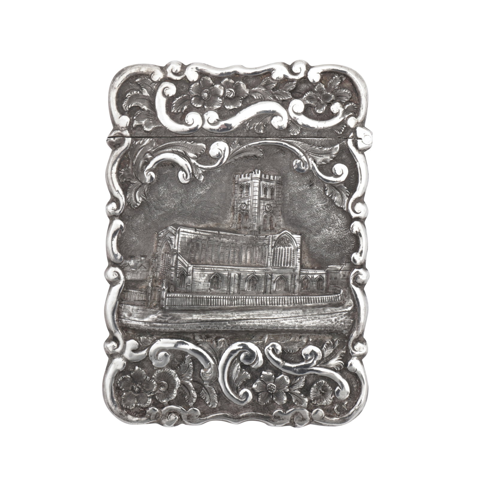 Birmingham 1871 by Hilliard and Thompson A cased Victorian sterling silver 'castle top' card case: Birmingham 1871 by Hilliard and Thompson A cased Victorian sterling silver 'castle top' card case Of shaped rectangular form with a hinged lid, the front with an embossed scene of an unidentified chur