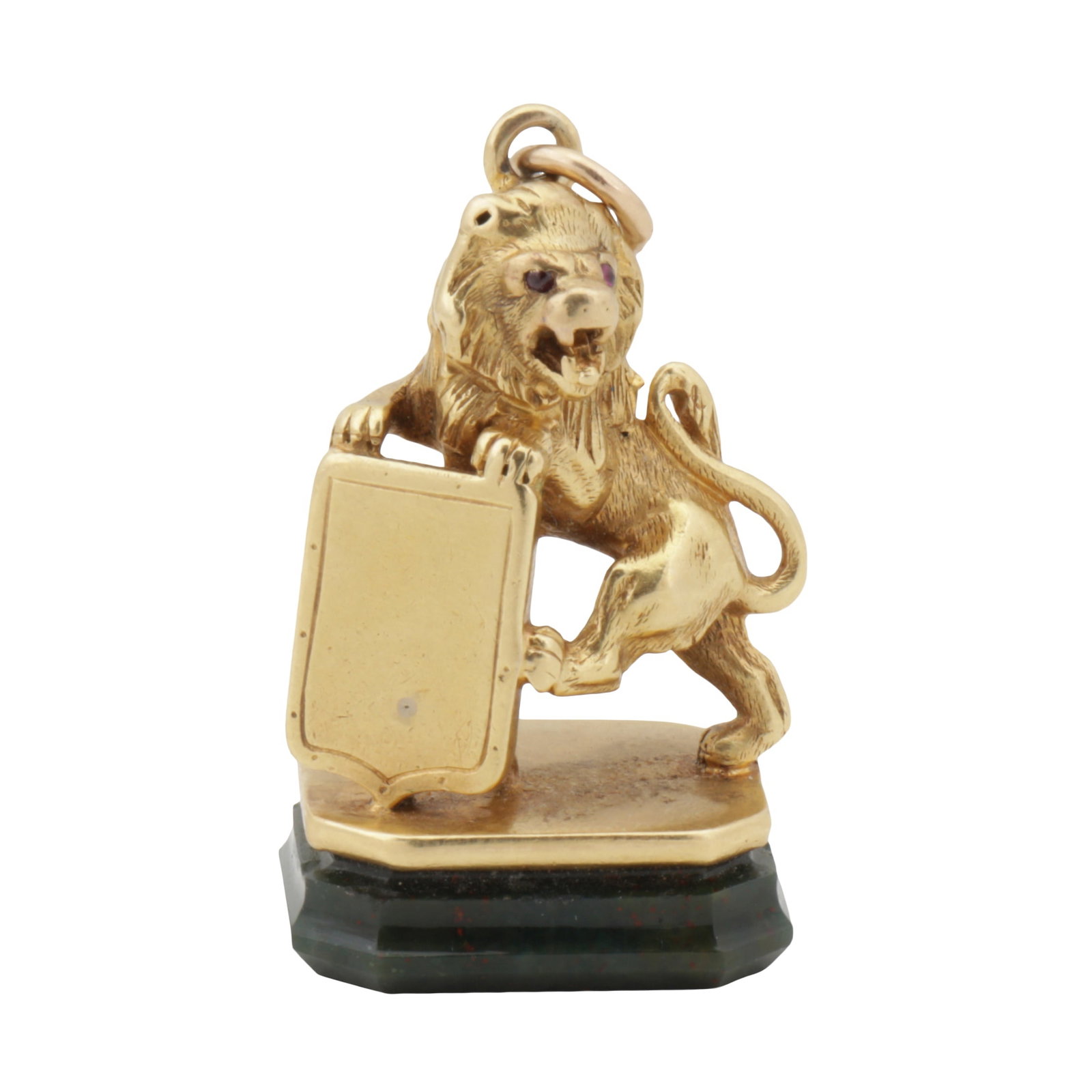 England circa 1860 A Victorian 18 carat gold and blood stone (heliotrope) seal: England circa 1860 A Victorian 18 carat gold and blood stone (heliotrope) seal Formed as a lion rampant guardant the paws upon a vacant escutcheon, vacant heliotrope base. Garnet set eyes. Suspension 