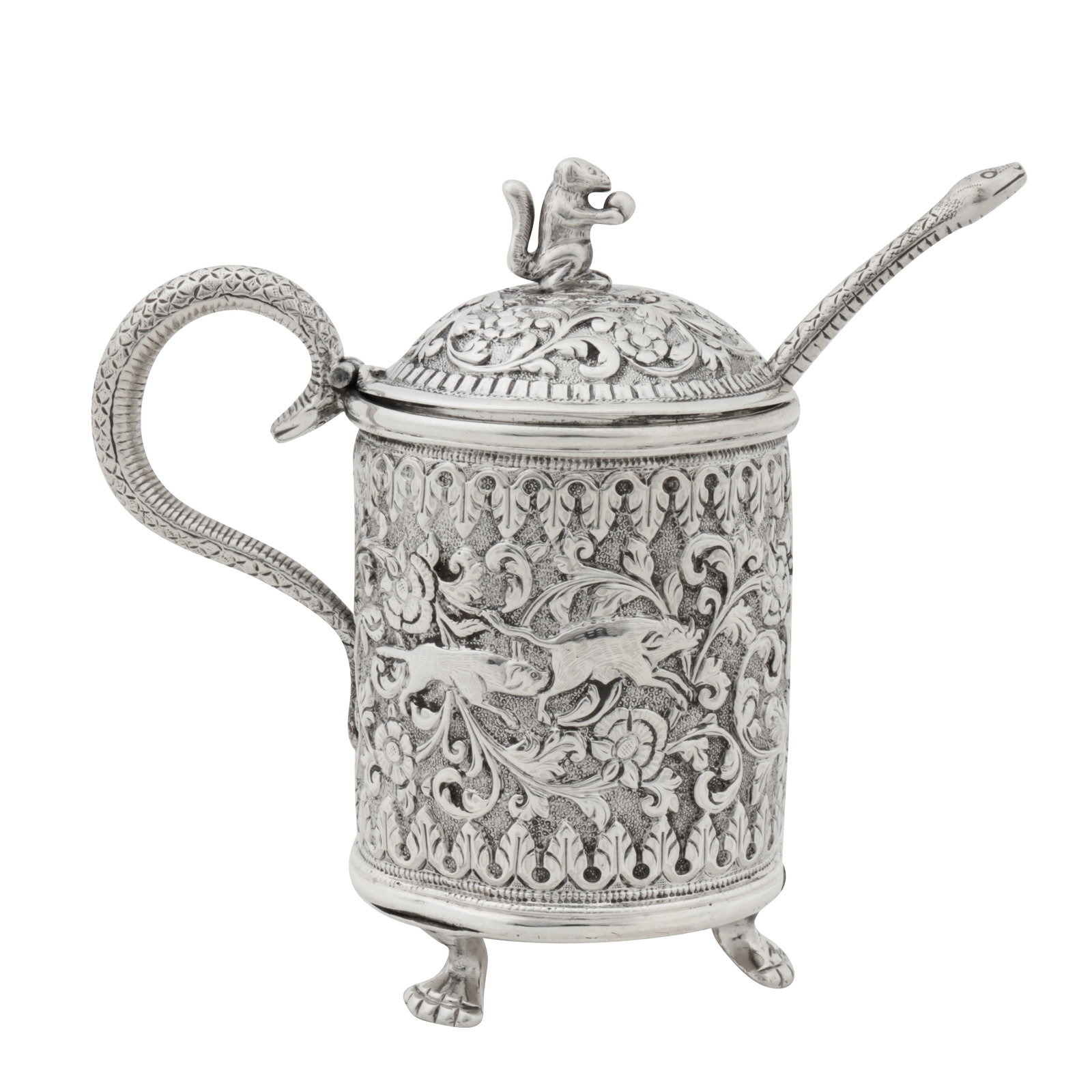 Cutch circa 1900 A late 19th / early 20th century Anglo – Indian unmarked silver mustard pot: Cutch circa 1900 A late 19th / early 20th century Anglo – Indian unmarked silver mustard pot Raj period. Of cylindrical form upon three paw feet. A chased serpent C scroll handle leading to a hinged