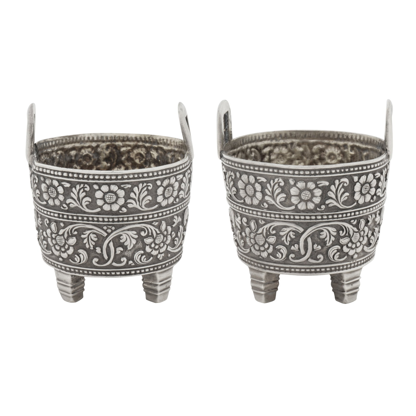 Cutch circa 1860 A pair of mid-19th century Anglo-Indian unmarked silver salts: Cutch circa 1860 A pair of mid-19th century Anglo-Indian unmarked silver salts Raj period. Each formed as a log bucket, of tapering cylindrical form upon four shaped square feet, with two loop carryin
