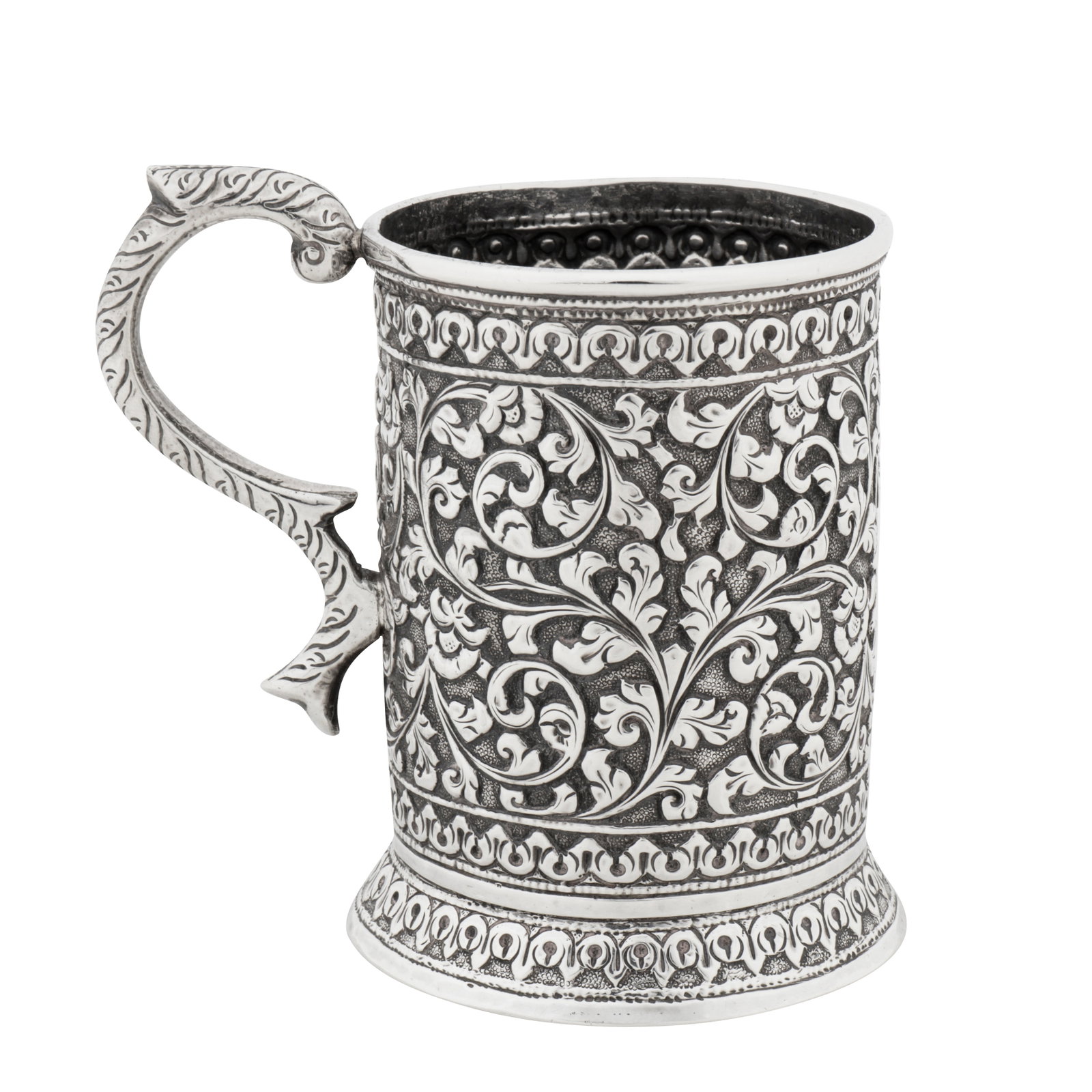 Cutch circa 1870 A late 19th century Anglo-Indian unmarked silver small mug: Cutch circa 1870 A late 19th century Anglo-Indian unmarked silver small mug Raj period. Of cylindrical form with a spreading foot, a C scroll handle with chased decoration. The body with chased decora