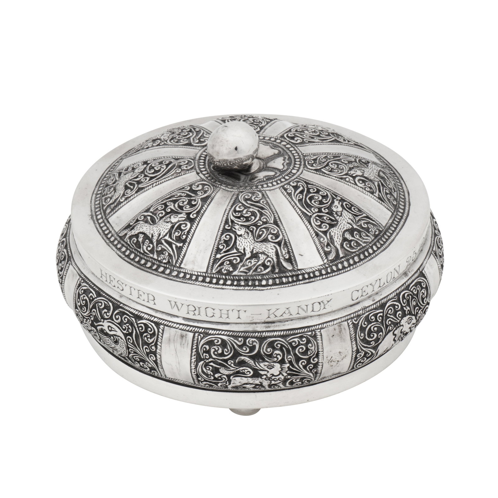 Kandy dated 1925 An early 20th century Ceylonese (Sri Lankan) unmarked silver dressing table box: Kandy dated 1925 An early 20th century Ceylonese (Sri Lankan) unmarked silver dressing table box Of compressed circular form upon three ball feet, a pull off domed lid surmounted by a knop finial. Cha