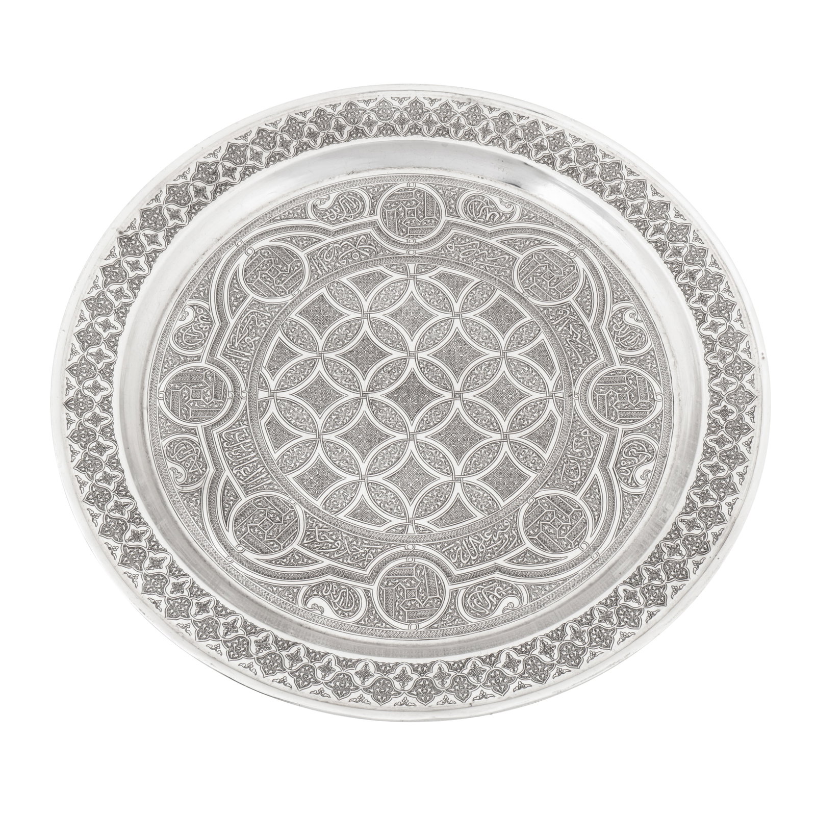 Cairo circa 1900 A late 19th / early 20th century Egyptian silver tray: Cairo circa 1900 A late 19th / early 20th century Egyptian silver tray Circular form with a broad edge and moulded rim. The field with engraved decoration in the Mamluk revival style, of intersected c