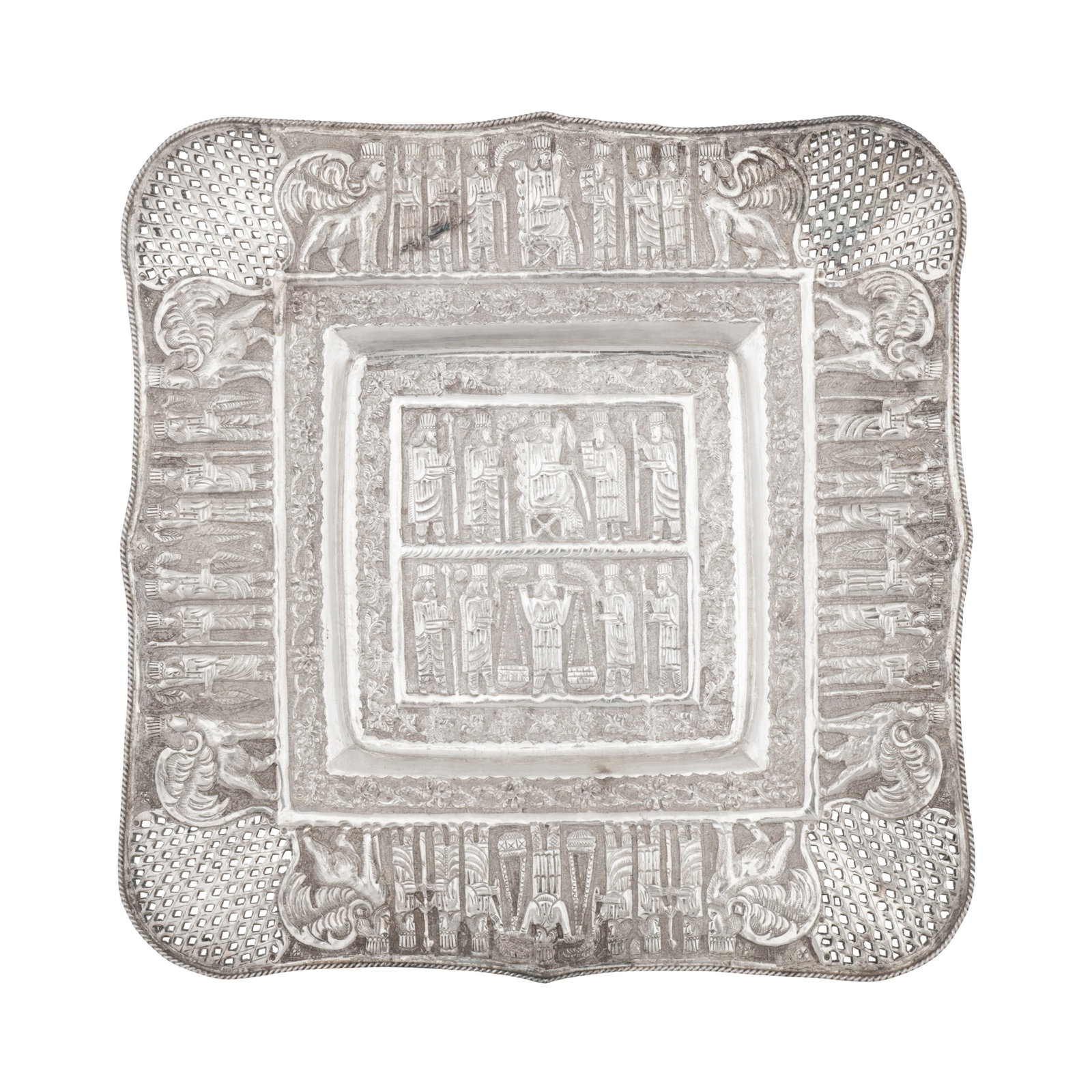 Shiraz circa 1950 A mid-20th century Persian (Iranian) unmarked silver tray: Shiraz circa 1950 A mid-20th century Persian (Iranian) unmarked silver tray Pahlavi dynasty. Of shaped square form with dished centre, raised upon four ball feet. The body with chased monabbat-kari de