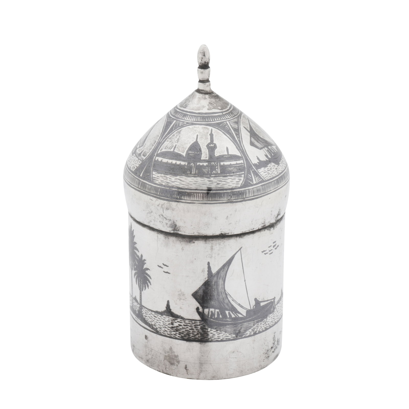 Omara circa 1930, signed Salih An early 20th century Iraqi silver and niello dressing table jar: Omara circa 1930, signed Salih An early 20th century Iraqi silver and niello dressing table jar Of cylindrical form with a pull off lid formed as a mosque’s dome. The sides with niello decoration of