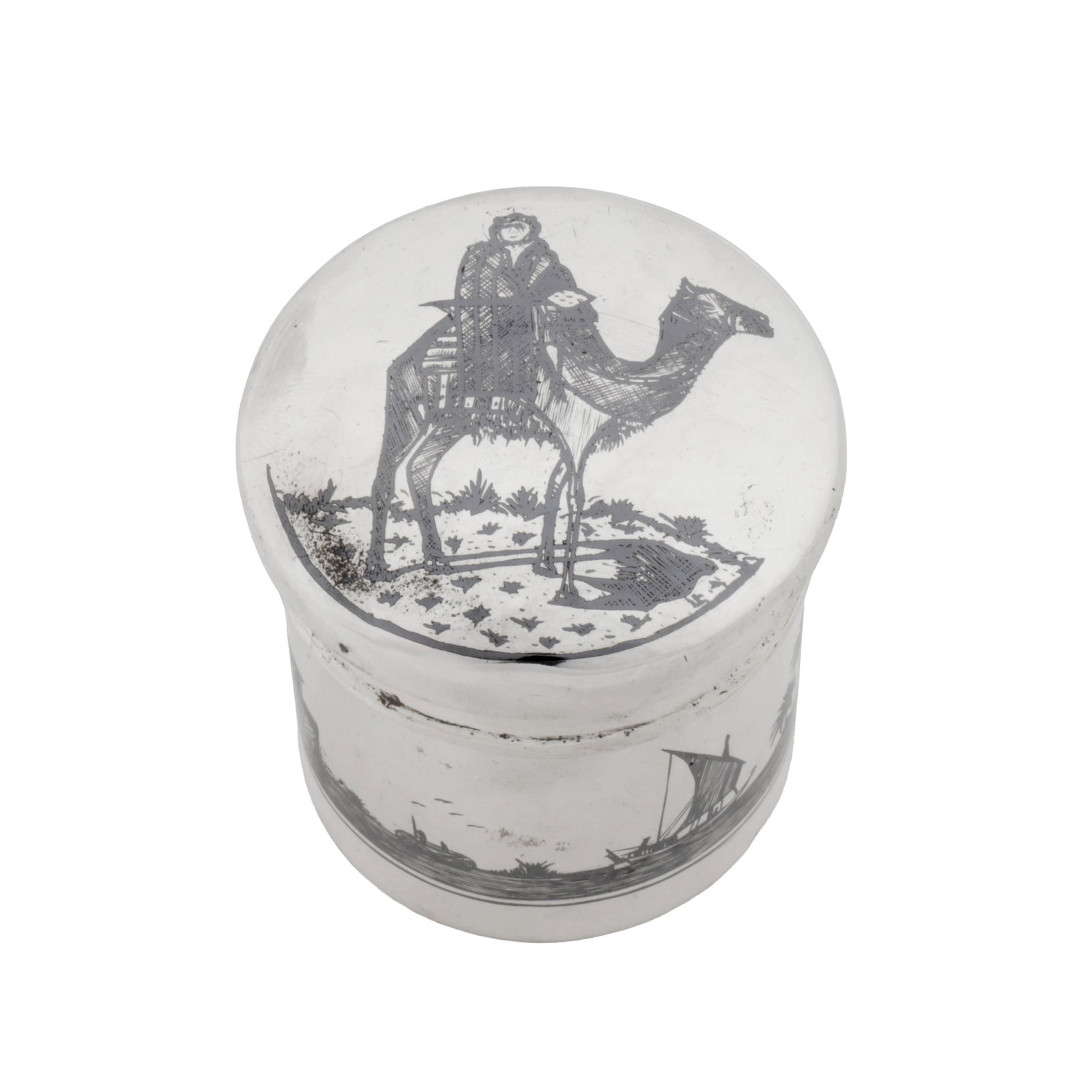 Omara circa 1920 An early 20th century Iraqi silver and niello dressing table jar: Omara circa 1920 An early 20th century Iraqi silver and niello dressing table jar Of cylindrical form with a domed lid. The sides with niello decoration of the Tomb of Ezra, the lid with a camel and r