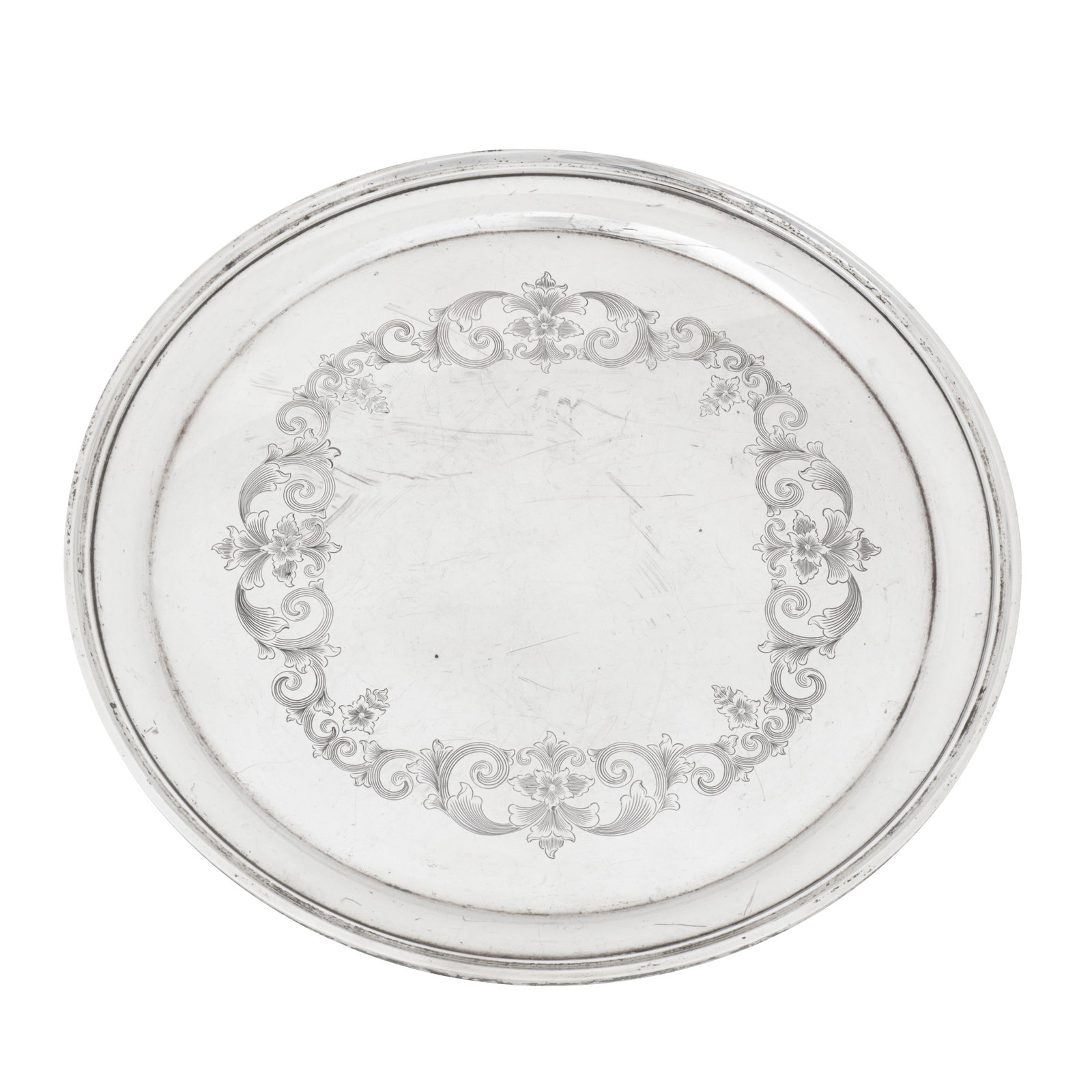 Baltimore circa 1950 by S Kirk and Sons A mid-20th century American sterling silver tray: Baltimore circa 1950 by S Kirk and Sons A mid-20th century American sterling silver tray Of circular form with ovolo edge and moulded rim. Engraved decoration of foliate scrolls. Diameter – 30.4 cm 