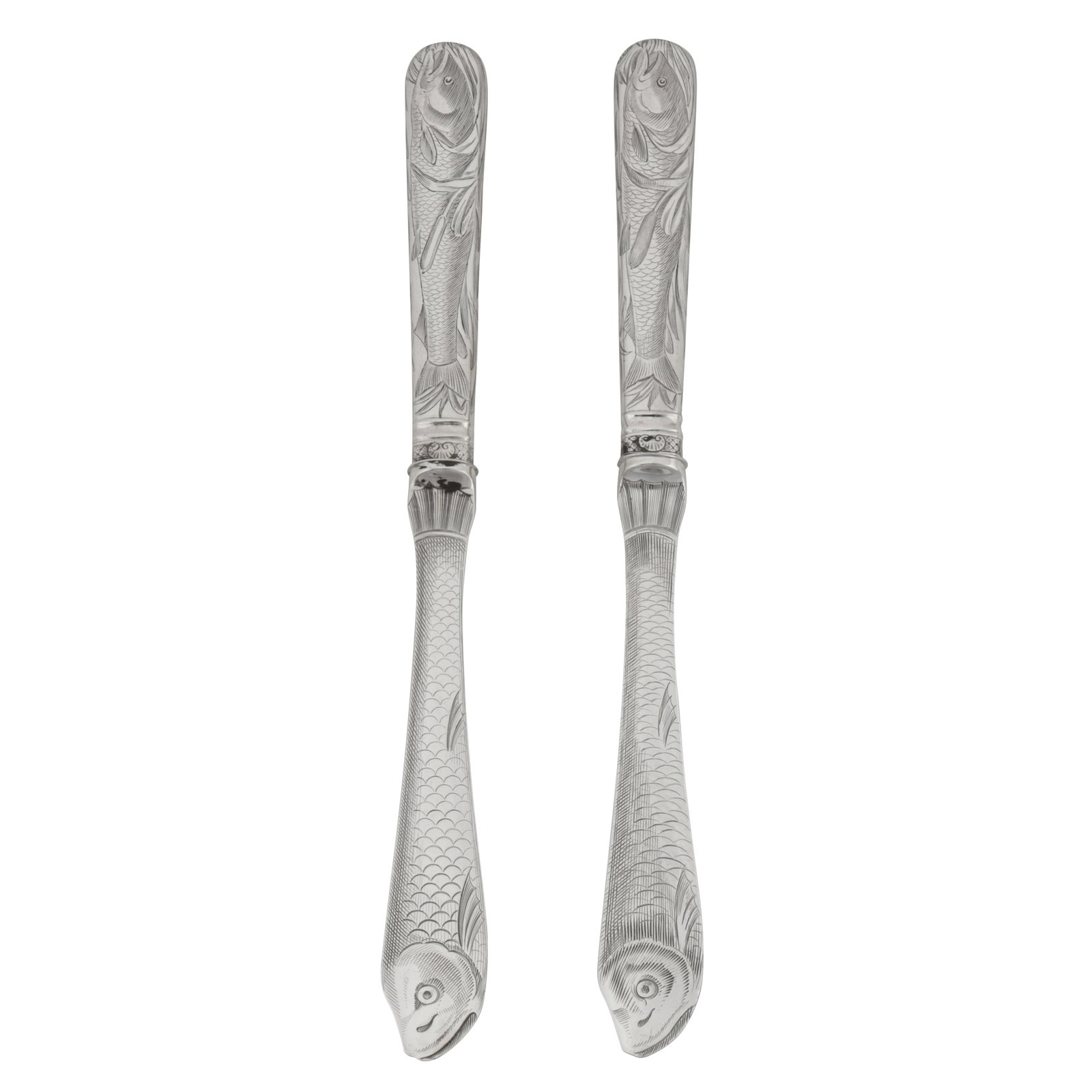 London 1846 by George Adams of Chawner and Co A pair of Victorian sterling silver fish knives: London 1846 by George Adams of Chawner and Co A pair of Victorian sterling silver fish knives The blades engraved as fish, the filled handles similarly so, a cartouche engraved with a crest of a tiger