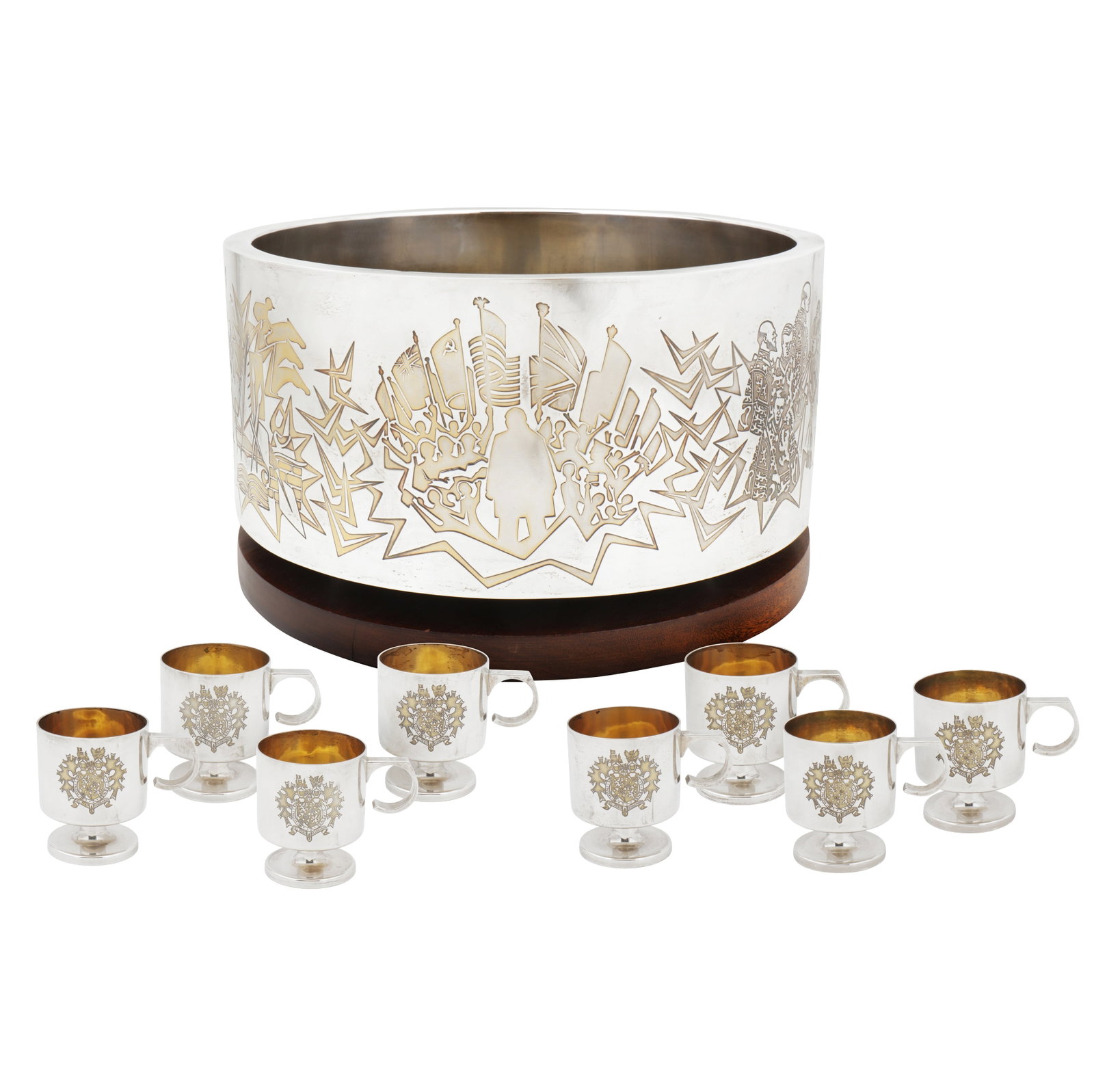 London 1974 by Garrard and Co, designed by Alex Styles An Elizabeth II parcel gilt sterling silver: London 1974 by Garrard and Co, designed by Alex Styles An Elizabeth II parcel gilt sterling silver commemorative punch set Comprising a punch bowl on wooden stand, punch ladle and eight punch cups. Th