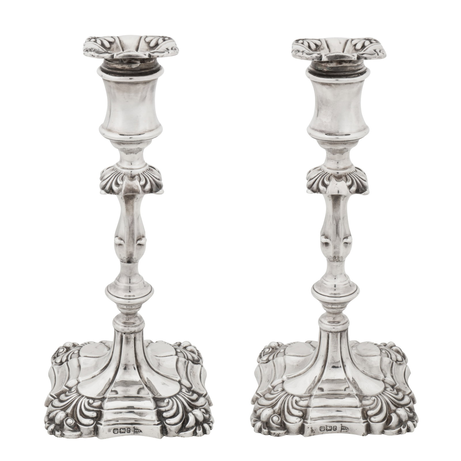 Sheffield 1897 by Walker and Hall A pair of Victorian sterling silver candlesticks: Sheffield 1897 by Walker and Hall A pair of Victorian sterling silver candlesticks Of shaped square form with shell capped corners, rising to a knopped and baluster column with s shaped square shell c