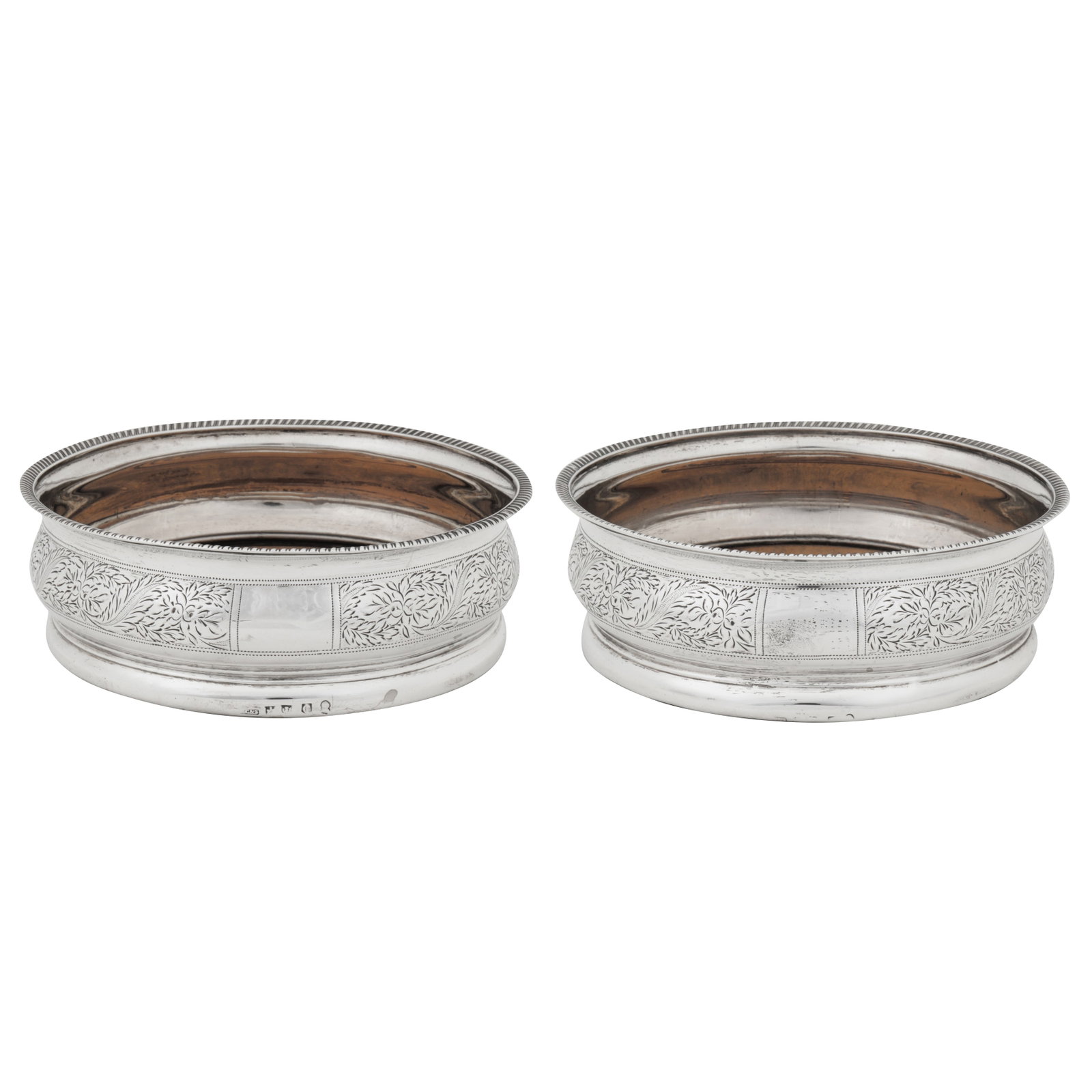 Edinburgh 1808 by Patrick Cunningham and Co A pair of George III Scottish sterling silver wine: Edinburgh 1808 by Patrick Cunningham and Co A pair of George III Scottish sterling silver wine coasters Each of compressed circular form with a gadrooned rim, engraved decoration of trailing foliage a